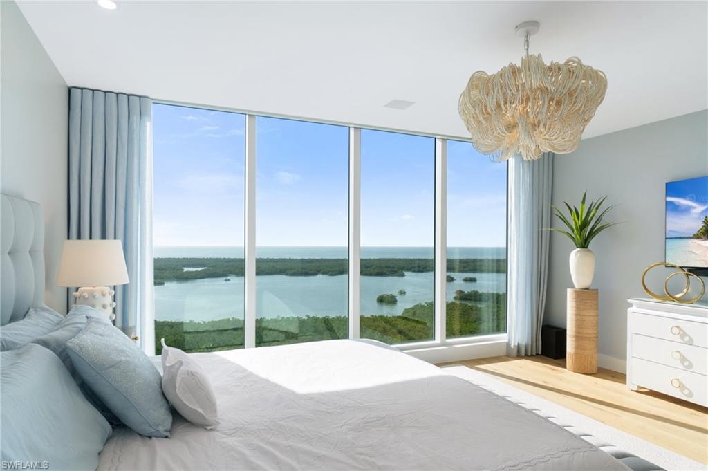 Indulge in a wealth of lavish upgrades and enhancements that define this rare Tower 400 sanctuary—a must-see masterpiece for the most discerning buyers. Welcome to the epitome of luxury living in the newest Tower 400, '02 unit on the 15th floor. This elegantly designed 4-bedroom, 3.5-bathroom residence spans an impressive 3,290 square feet, offering unparalleled sunset vistas of the Gulf and Wiggins Pass, along with breathtaking sunrise views over the clubhouse and the prestigious Kinsale Golf Course.

Expertly curated by the nationally acclaimed interior designer Renee Gaddis, this residence is a testament to craftsmanship and style. Immerse yourself in the opulence of Legno Bastone European white oak wood floors, complemented by exquisite custom chandeliers, wall sconces, drapery and wallpapers from renowned designers Schumacher, Phillip Jefferies, and Thibaut. The sophisticated living space boasts a custom built-in Dimplex Ignite fireplace and meticulously upgraded cabinetry.

The gourmet kitchen is a culinary haven, with upgraded quartz countertops, premium Wolf and Sub-Zero appliances, a natural gas cooktop, dual Bosch dishwashers, a built-in Miele coffee/espresso machine, and a Kinetico reverse osmosis system. Maximize storage space with upgraded custom built-in cabinetry in the laundry room, the master bedroom walk-in closet, and refined cabinetry in bedrooms 2 and 3. 

Effortless living is ensured with automated shutters, lighting, and music, all managed by an advanced premium Smart Home system. The expansive patio lanai, equipped with an outdoor TV and speaker system, is safeguarded by hurricane shutters, providing peace of mind while you're away. Ascend a few floors to the rooftop terrace pool to savor a sunset, or stroll across the street to the five-star luxurious clubhouse, boasting three pools, two gourmet restaurants, a wellness center, pickleball, tennis, and more.

Welcome to an uncomplicated, coastal luxurious lifestyle at Kalea Bay, where elegance meets ease and every detail is designed for your utmost pleasure.