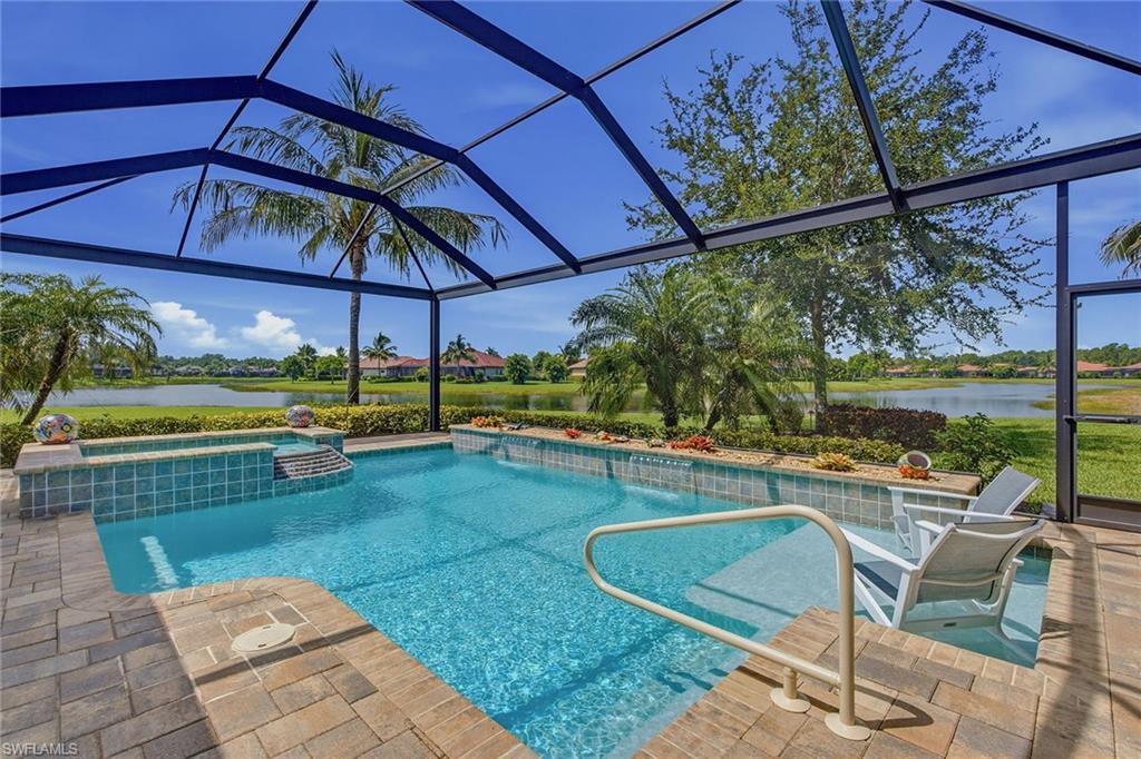 Perfectly positioned on an oversized homesite with an exceptional long lake view, this meticulously maintained residence offers the space, natural light and indoor-outdoor lifestyle that define Florida living. Desirable SE exposure fills the home with morning light and sunrises while creating a comfortable setting for afternoon relaxation on the large screened lanai. Offering nearly 3300 square ft living space, three bedrooms plus a den, four full baths, including a pool bath, and a two-car garage, the home is surrounded by lush tropical landscaping and enjoys wonderful privacy. A welcoming entry introduces soaring ceilings, French doors, crown molding, wainscoting and porcelain tile flooring throughout the main living areas. The spacious living room features an exquisite tray ceiling and expansive sliding glass doors framing the sparkling pool and panoramic lake beyond. The inviting family room is ideal for everyday living and effortless entertaining. Designed for beauty and functionality, the kitchen features white cabinetry, granite counters, glass tile backsplash and under-cabinet lighting. A generous center island provides ample preparation and gathering space, while the walk-in pantry offers storage. Premium stainless appliances include a French-door refrigerator, convection wall oven, microwave, five-burner natural gas cooktop and exhaust hood. The spacious primary suite is a serene retreat with a tray ceiling, crown molding, plantation shutters, private lanai access and two walk-in closets. The spa-inspired bath features dual vanities, a soaking tub, curbless walk-in shower, linen closet and water closet. Two guest bedrooms provide private accommodations for family and visitors, complemented by adjacent baths. The versatile den is ideal as an office, media room or guest space and features plantation shutters, crown molding, recessed lighting and sliding glass doors to the lanai. Outdoors, the expansive paver lanai and panoramic screen enclosure showcase the extraordinary lakefront setting. A summer kitchen with built-in grill makes alfresco entertaining effortless, while the saltwater pool and spa invite year-round relaxation. Impact-resistant windows throughout and Storm Smart lanai shutters provide peace of mind. Two HVAC systems and a tankless natural gas water heater enhance comfort and convenience. The garage features built-in shelving. Within award-winning Fiddler’s Creek, residents enjoy miles of beautifully landscaped, tree-lined sidewalks ideal for running, walking and bicycling amid natural beauty. Manicured landscaping, shimmering lakes and peaceful preserves create a gorgeous setting throughout the community. The gated lifestyle centers around a spectacular clubhouse with resort-style pools, dining, fitness center, spa services, tennis, bocce and 10 pickleball courts. Optional memberships are available for championship golf, a private beach club and marina.