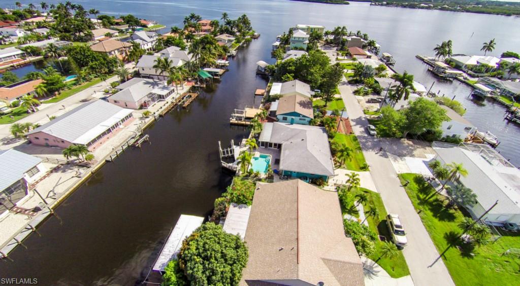 WHAT A VIEW!! DIRECT WATERFRONT OPEN CONCEPT HOME HAS IT ALL IN ARTSY MATLACHA.QUICK ACCESS TO MATLACHA PASS. UPDATED HICKORY KITCHEN CABINETS, QUARTZ COUNTER TOPS, ECLECTIC KITCHEN LIGHTING WITH STAINLESS APPLIANCES. NEW HAND SCRAPED ACACIA WOOD FLOORING IN ALL MAIN LIVING & FAMILY RM. AREAS. TAVERTINE IN MASTER BED & BATH WITH 2 NICE SIZE WALK IN CLOSETS.
POOL & PATIO THAT SITS AT EDGE OF THE DEEP WATER CANAL. SLIDING GLASS DOORS OFF MASTER BEDROOM TO POOL. LOWER LEVEL PATIO OFF 10,000 BOAT LIFT & DOCK. NICE SIZE LOT WITH SECURED FENCE  ON SIDES  WITH  PET RUN AREA. ONE CAR GARAGE & STORAGE.   GREAT INVESTOR OPPORTUNITY.