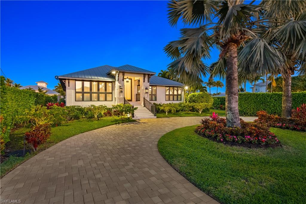 Discover refined waterfront living in Royal Harbor at this fully reimagined coastal residence set on an oversized corner lot with direct Gulf access. Completely renovated, the home blends timeless design, functionality, and resort-inspired amenities just minutes from downtown Naples and the beach. Light-filled interiors feature soaring ceilings, wide-plank wood floors, custom millwork, and expansive impact glass throughout that creates a seamless connection to the outdoor living spaces.
The open-concept layout is designed for both everyday living and entertaining, anchored by a chef’s kitchen with premium custom cabinetry, striking stone surfaces, an oversized island, and Wolf and Sub-Zero appliances. The private primary suite offers a custom walk-in closet, a spa-inspired Carrara marble bath with soaking tub and oversized shower, and a covered terrace overlooking the pool—an ideal setting for quiet mornings or evening relaxation. Guest bedrooms are spacious and well-appointed with beautifully finished baths and generous storage.
Outdoor living is designed to rival a private retreat, featuring a deep heated pool, cedar-wood sauna, covered lanai, outdoor kitchen, and custom coral stone detailing. Mature landscaping provides privacy while multiple seating areas create an ideal setting for entertaining. Boating enthusiasts will appreciate the dock, commercial boat lift, and dredged canal offering improved water depth and easy Gulf access.
Additional highlights include an air-conditioned garage with custom cabinetry and upgraded flooring. 
Located in one of Naples’ most desirable waterfront communities, Royal Harbor offers close proximity to 5th Avenue South, Third Street South, fine dining, shopping, and the vibrant downtown lifestyle. A rare opportunity to own a move-in ready waterfront home where design, comfort, and lifestyle come together effortlessly.