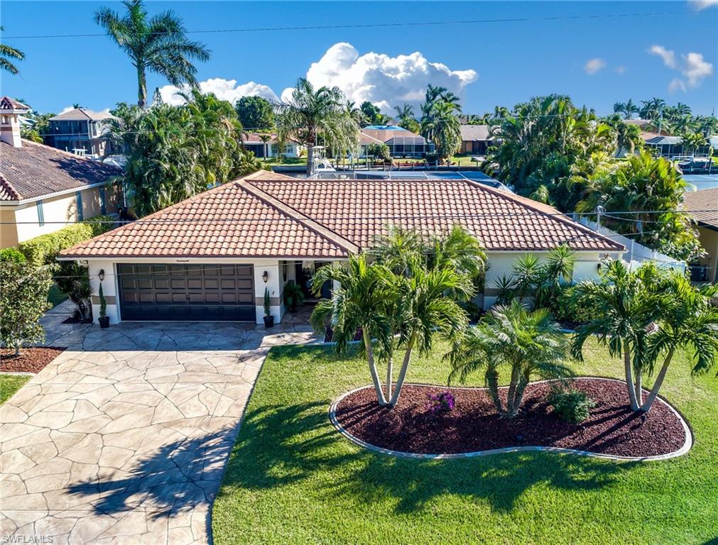 STUNNING! Exquisite home in beautiful Savona Pkwy area & MOVE-IN ready on a DIRECT GULF ACCESS deep, 200+ wide canal. Drive up to the professionally landscaped lot, mature palms, over-sized decorative driveway w/4' wide continuous walkway to the mega dock. The quality of upgrades is incredible! Custom window treatments, new lighting, tray ceilings, picture window and custom entertainment center in formal living room. The designer kitchen overlooks the deep & heated over-sized pebble-tech pool with waterfall & separate Hot Tub with therapy jets. Pocket sliders in the dining area and family room, plus the pocket slider kitchen window open the house up to enjoy the outdoors. Step out onto the stamped concrete, screened lanai to grill on the custom built outdoor kitchen with lighting & ice maker. East exposure & gorgeous morning sunshine! The roof is metal barrel Dura-Loc with transferable warranty. Private area with 6' vinyl fence suitable for dog run at the side of the house. Large wrap around dock with a 24k lb "High Tides" boat lift, twin 30amp service and one 50amp plug in, water & extended pilings on the outside for larger boats. BOATERS DREAM and a MUST SEE! WATCH VIRTUAL TOUR!