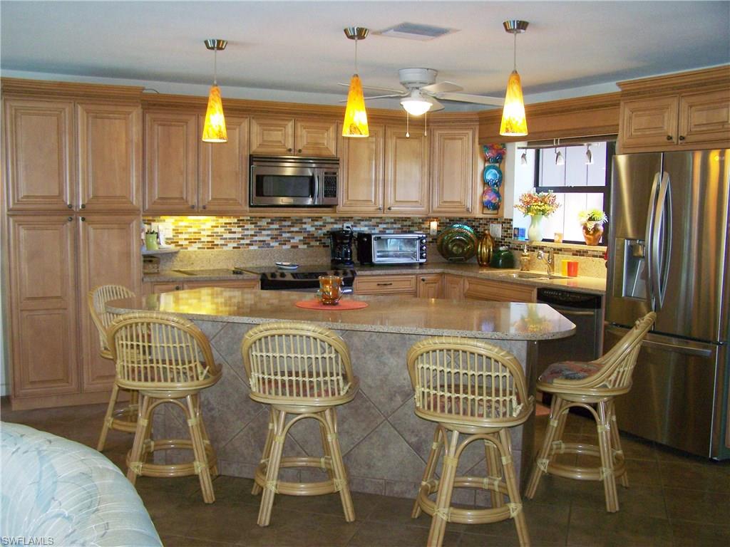 This Direct Deep Water, Gulf of Mexico, Sailboat access home used to be 3 bedrooms & could have 4.  Owners opened up home for entertaining. Easy to remedy if you need a 3 or 4 bedroom.  Large neutral tiles throughout. Quartz counters, richly appointed cabinets in the kitchen, & granite counters in the Master & Guest Bathrooms displays the meticulous care this home has had.  In addition to a cooktop range there is a 6 burner JennAire grill. Siesta Isles is known for the best direct boating access in Lee County. Main dock located in center of 104' seawall has a 24,000 lb lift & cleaning table; 2 additional davits & concrete pad provide space for a runabout & a seawall Boat Hoist has room for 2 jet skis. New roof in 11/2013.  Roll down impact Hurricane protection was installed in 2014 and 2015. Huge lanai has abundance of shaded & sunny areas. The solar heated pool provides for hours of entertainment & on chilly days, you can supplement the solar with a new heat pump pool heater (1 year old). Your irrigation comes from a 400' deep well. Drinking water comes from the Public system.  Bahamian Shutters. Large closets. Oversized 2 stall garage. Pool bath. 1 electric fireplace stays.