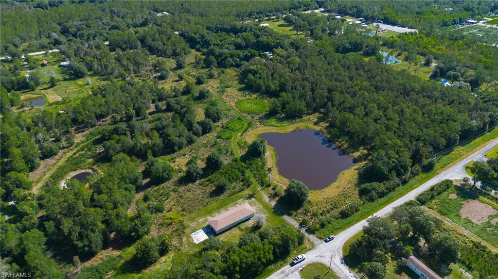 Embrace the beauty and potential of this remarkable 9.55-acre wooded property featuring its own serene lake. Enjoy peaceful fishing, birdwatching, and the tranquility of nature from your private retreat. Perfectly square in shape and partially fenced, this land offers exceptional privacy with towering trees and lush natural foliage. Whether you envision a secluded estate, weekend getaway, or investment opportunity, this versatile parcel provides endless possibilities. The lot may be divided into two parcels, offering flexibility for multiple homesites or the option to maintain one expansive sanctuary. Ideal for residential use, equestrian activities, grazing, hobby farming, livestock, or recreational enjoyment, the land supports a wide range of future improvements and development plans. The property includes an existing garage with electricity, plus a well and septic system—perfect for storage, a workshop, or housing recreational equipment. With ample space to build and nature all around, this is an ideal setting for those seeking peace, privacy, and long-term potential. Located in the desirable Corkscrew area, the land is surrounded by approximately 64,000 acres of protected preservation areas, including the Audubon Corkscrew Swamp Sanctuary, CREW Bird Rookery, and Lake Trafford—ensuring lasting natural beauty and abundant wildlife. Don’t miss this opportunity to own a private, wooded haven with unmatched versatility and charm.
