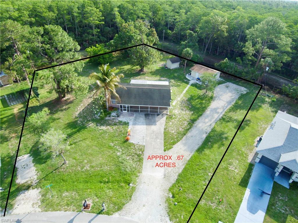 Situated on a rare double oversized lot spanning nearly 3/4 of an acre, this unique property offers privacy, space, and beautiful preserve views along the canal bordering the rear half of the property. Surrounded by mature vegetation and fruit trees including mango and star fruit, the setting feels peaceful and tucked away while still offering ample usable outdoor space.
The well-maintained main residence features 3 bedrooms and 2 bathrooms, including a generously sized primary suite. Inside, you’ll find a spacious living room and dining area, a bright sun room, and an ample kitchen equipped with stainless steel appliances, including a newer refrigerator and stove.
Outdoor living is enhanced with two screened lanais, with the rear lanai offering laundry hookups for added convenience.
Adding even more versatility is a charming guest house complete with a small kitchen, 2 bedrooms, and a full bathroom — ideal for guests, extended family, rental potential, or a private workspace.
The expansive property also includes a storage shed and abundant room for vehicles, boats, trailers, gardening, or additional outdoor storage possibilities.