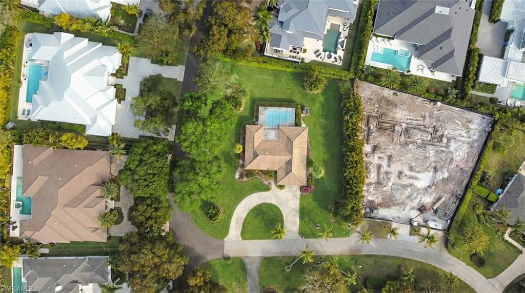 690 Murex Drive is set on a rare half acre corner lot in the heart of Coquina Sands, one of Naples’ most established and walkable neighborhoods. The southern oak lined streets are quiet, shaded, and filled with neighbors out walking dogs, pushing strollers, and riding bikes to the beach. This is old Naples living the way people picture it.

From your front door, you are approximately a 10 minute walk to Lowdermilk Park, where you have direct beach access, picnic areas, volleyball courts, and Gulf sunsets year round. You are also just a short bike ride to Fifth Avenue South for dining, shopping, coffee, and events, and close to Third Street South, Cambier Park, and the Naples Beach area. Everything that makes Naples special is right around you.

Coquina Sands is known for being pet friendly and community oriented. The neighborhood dog walking club is active, and you will regularly see small groups gathering in the mornings and evenings along the oak canopy streets. It feels residential and private, yet you are minutes from downtown and the Gulf.

The lot itself is one of the standout features. A true half acre corner homesite offers flexibility, privacy, and presence. Corner lots in this part of Coquina Sands are highly desirable because they allow for creative new construction designs, larger footprints, generous outdoor living space, and strong curb appeal. If you are looking to build your dream home in the heart of Naples, this is the type of property that supports a statement residence.

There is tremendous upside potential here for new construction. Surrounded by luxury new builds and high end remodels, this location supports significant investment. Whether you envision a modern coastal estate with a resort style pool and expansive outdoor entertaining areas, or a classic Old Naples inspired design, the setting and lot size give you room to execute at a high level.

Currently on the property is a charming 3 bedroom, 2 bath home with good bones and character. The existing residence offers flexibility. You can enjoy it as is, renovate and update over time, or use the lot as the foundation for a completely new build. The home sits comfortably on the site, and the corner positioning creates a sense of openness and space.

Opportunities like this in Coquina Sands are limited. A half acre corner lot, walking distance to Lowdermilk Park, bike ride to Fifth Avenue, and surrounded by some of Naples’ most desirable streets. Build your vision right here and create something special in one of the most sought after neighborhoods in Southwest Florida.