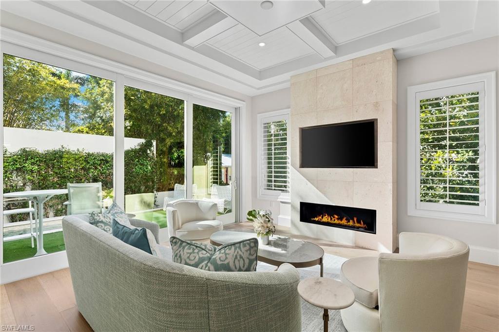 New construction single family home in the heart of Olde Naples built in 2024 for under $3.5M! This never lived in distinguished two-story pool residence embodies the timeless charm of cottage living . Thoughtfully designed with 1,976 square feet under air, the home blends classic coastal architecture with elevated modern comforts. The gracious floor plan offers a spacious first-floor primary suite, providing a private sanctuary with a spa-inspired bath, walk-in closet, elegant finishes and serene proportions. Throughout the home, warm-toned wide-plank wood flooring creates continuity and warmth, bespoke detailing, plantation shutters and a curated selection of luxury appliances. The gourmet kitchen includes custom cabinetry, a beautiful wraparound backsplash, quartz countertops, soft brass finishes, and a convenient center island with a two-drawer refrigerator and freezer. Designed for formal and relaxed entertaining, the open great room with floor-to-ceiling tiled linear gas fireplace and TV shelf flows seamlessly into a beautiful, dedicated dining area, both overlooking the inviting and outdoor deck and pool, an ideal setting for intimate gatherings, morning coffee or quiet afternoons. The second level reveals a refined open loft, ideal for a sitting room or reading retreat, along with two generously sized en-suite guest bedrooms and a generous and thoughtfully designed laundry room. Clive Daniel Homes furnished the home, and it is being sold with furnishings. Positioned within short distance to Fifth Avenue South and just minutes from the Gulf beaches, this exceptional residence places you in the heart of downtown Naples, surrounded by fine dining, boutique shopping, galleries and theatres, capturing the spirit, and enduring coastal elegance and vibe of Old Naples.