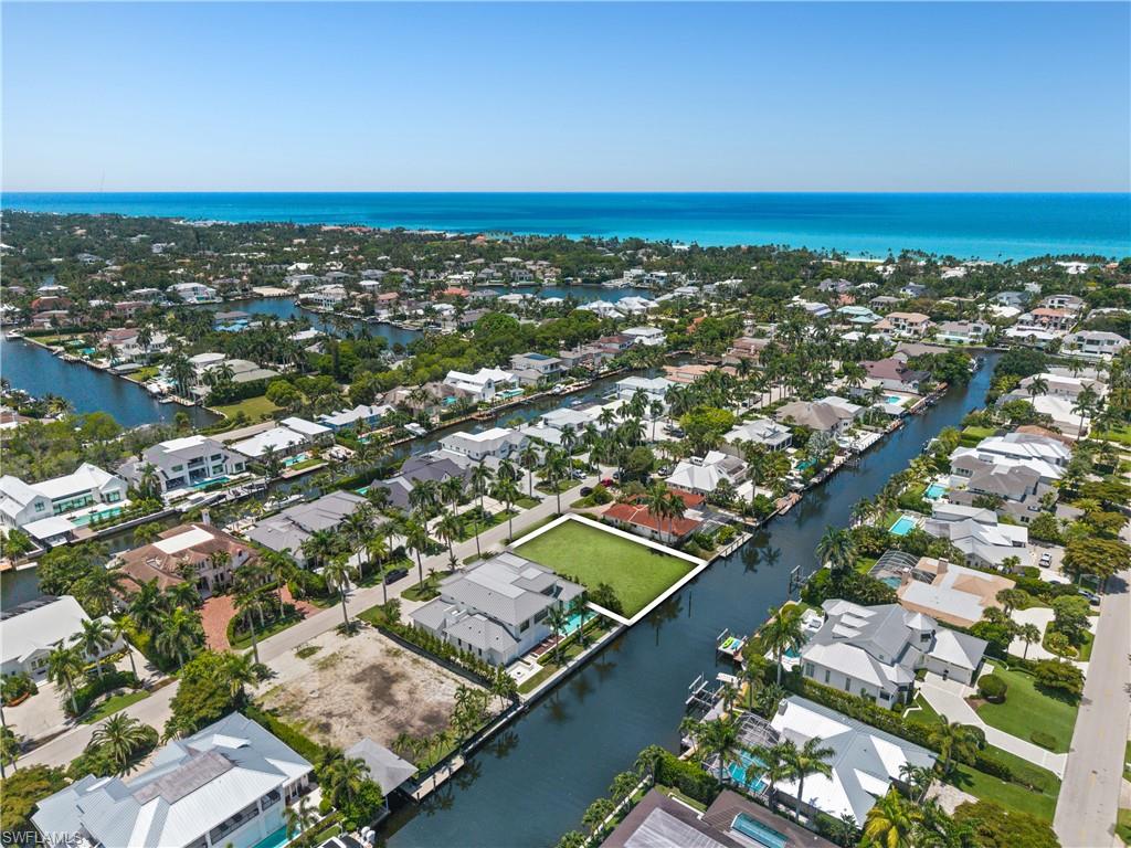 This exceptional waterfront homesite offers an unparalleled boating lifestyle with direct Gulf access and no bridges for effortless days on the water. Enjoy the remarkable convenience of Third Street South shopping and dining just moments away, while sandy Gulf beaches are only just moments away from your doorstep. This approximately 0.30-acre cleared parcel presents a rare opportunity to design and build a custom residence tailored to your vision.