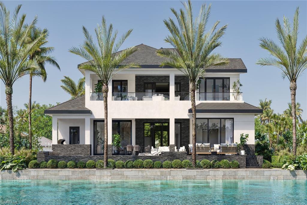 Under construction by the regarded Lusso Builders with an estimated 2026 completion, this exceptional two-story waterfront residence offers preferred southern exposure and desired Gulf boating access, delivering a refined blend of architectural presence and coastal functionality. Thoughtfully designed for modern living, the home features four bedrooms, five and a half baths, a private elevator, and two separate garages with space for three cars and abundant storage. From the moment you arrive, the tile roof, grand iron double-door entry, and elevated foyer set the tone for a striking coastal retreat built for everyday comfort and elevated entertaining. Inside, porcelain tile flooring flows throughout, complemented by modern ceiling fans and exquisite handmade Amish interior cabinetry that adds warmth, craftsmanship and character across the home. Expansive living spaces are enhanced by impressive glass sliders that seamlessly connect the interior to the outdoor living areas, inviting natural light and embracing the indoor-outdoor lifestyle that defines island living. The open living room flows effortlessly to the lanai, creating an ideal setting for gatherings overlooking the pool and spa. The chef’s kitchen is a showpiece, featuring rich Danish walnut cabinetry, quartz countertops with a matching backsplash and a statement island accented by elegant glass pendant lighting. A pot filler, walk-in pantry and premium appliances, including a Wolf eight-burner dual fuel range and Sub-Zero refrigerator, make this space as functional as it is visually stunning, ideally suited for culinary creativity and entertaining. The primary suite offers a serene retreat with private lanai access and two spacious walk-in closets. The spa-inspired primary bath features a double vanity with porcelain countertops, a walk-in shower with tile walls, a separate soaking tub and a private water closet. Three additional guest suites provide exceptional comfort, with two offering direct access to a covered terrace and all featuring walk-in closets and en-suite baths with quartz countertops and walk-in showers. Outdoor living is elevated with a large covered lanai, resort-style pool and spa, and a fully equipped outdoor kitchen complete with a grill and icemaker, ideal for waterfront entertaining. The well-appointed laundry room includes a washer and dryer, quartz countertops, tile backsplash, utility sink and storage cabinetry for everyday ease. Just moments from Marco Island’s pristine beaches, upscale boutiques, fine dining, parks, museums and golf courses, this home offers an ideal blend of coastal luxury and an active waterfront lifestyle. Whether kayaking, paddleboarding, biking, pickleball, tennis or yoga on the beach, the island’s best experiences are right at your doorstep, with the nearby executive airport providing effortless travel. Extraordinary opportunity to own a new island home without a long wait!