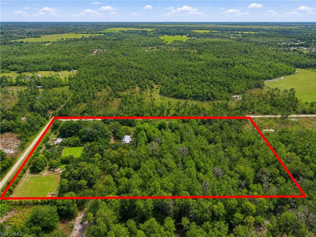 A RARE FIND IN ONE OF THE MOST UP AND COMING AREAS IN FORT MYERS! Almost 8 acres of land - corner parcel w/ road frontage on 2 sides. This property is zoned AG-2 for one single family home. Being sold as VACANT LAND, INCLUDING the trailer on the land. For outdoor enthusiasts, the property features a private target range area along with a fully stocked pond where you can spend relaxing afternoons fishing for bass and tilapia. This unique acreage offers the perfect setting to build your dream home surrounded by mature peach, avocado, sour orange, and key lime trees. With a well and septic system already in place, much of the groundwork has been completed. Enjoy the peace, privacy, and charm of country living while remaining just a short drive from shopping, dining, schools, and everyday conveniences.