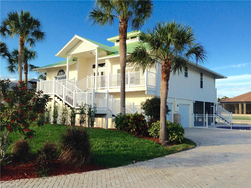 Beautifully newly renovated in 2016. Old Florida Style Key West home, on indirect water with dock, lift, and pool with direct southern exposure. New kitchen cabinets, dishwasher, and microwave. Like new refrigerator (2yrs old). New gorgeous granite counter-tops and tile flooring throughout. New bedroom carpeting. New bathrooms. New Jacuzzi tub in master bath. Brand new A/C. Lovely very large screened-in entertainment area. Spectacular newly finished FOUR car garage.
