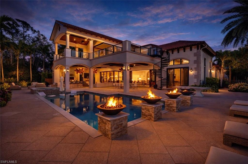 GOLF MEMBERSHIP AVAILABLE — Elegantly positioned on one of Talis Park’s most coveted golf frontages, this Santa Barbara Grande estate exemplifies refined Naples living and custom architectural excellence. Designed by Herscoe Hajjar Architects and masterfully built by Sunwest Homes with interior artistry by Design West, this residence offers nearly 6,000 sq ft of luxury living (9,210 sq ft total), tailored for both grand entertaining and serene everyday enjoyment.

Step into an expansive floor plan where a light-filled multi-island kitchen flows effortlessly into the generous gathering and dining spaces, anchoring the heart of the home. The main level includes a sumptuous Master Retreat with private golf views, two ensuite guest bedrooms, a dedicated wine room, and a powder bath. Oversized 10’ sliding glass doors disappear to reveal an extraordinary outdoor living experience with a gas fireplace, fully equipped outdoor kitchen, custom pool and spa, and cabana bath—creating an unmatched indoor-to-outdoor lifestyle.

Upstairs, an additional spacious Master Suite is accompanied by an expansive sitting room/bonus living area perfectly suited for relaxation, media, fitness, or office use. A covered balcony and generous sun deck overlook the lush fairway vistas of the newly updated golf course, creating yet another private retreat.

Quality finishes throughout include vaulted and barrel ceilings, extensive custom woodwork and trim, polished marble inlays paired with hand-scraped hardwood floors, Thermador appliances, and a Sonos sound system.

Located within the exclusive Prato enclave of Talis Park, residents enjoy access to premier membership amenities, including a championship Greg Norman and Pete Dye–designed golf course, world-class dining, tennis and pickleball courts, bocce, fitness and spa facilities, scenic paths, and concierge services—all just minutes from Naples’ iconic beaches, upscale shopping, and fine dining.