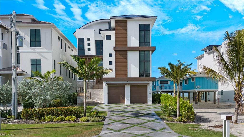 This is the toes-in-the-sand opportunity you have been waiting for! Brought to you by an award-winning team, this 2023 Bonita Beach home was designed by architect Rich Guzman and built by Potter Homes with world-class interior design by Adelyn Charles Interiors. Thoughtfully designed for entertaining, the home features a true chef's kitchen with Subzero/Wolf appliances, gas range, two oversized islands, and a hidden butler’s kitchen and walk-in pantry. Enjoy stunning watercolor sunsets from the expansive outdoor living area with infinity-edge saltwater pool, hot tub, fireplace, and a large outdoor kitchen. The primary suite is a true oasis, allowing you to fall asleep to the gentle sound of waves, with dual walk-in closets and a spa-like bathroom with steam shower. Your guests will feel right at home in the home's four ensuite guest rooms and separate living areas. Smart home automation by Control4, 7+ car garage with EV charging, and elevator service to all floors add to the home's exceptional functionality. Over $900,000 in custom upgrades! Conveniently located just 30 minutes from RSW and Naples airport and 15 minutes from Mercato/Waterside Shops, this fully furnished property is just steps from the beach. This home has too many features to list and must be seen in person to be appreciated fully. To experience SWFL living at its finest, schedule a private showing today.