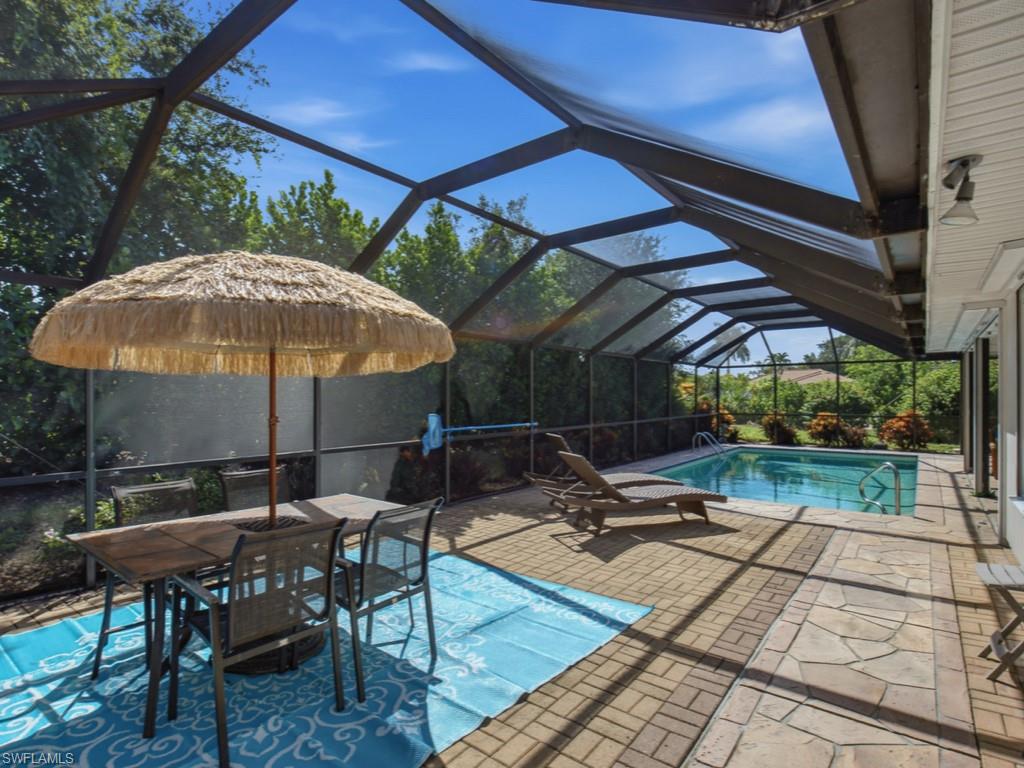 Discover the appeal of Marco Island living in this beautifully updated and tastefully furnished 3-bedroom, 2-bath residence, ideally positioned on a quiet street just minutes from the island's renowned white-sand beaches and the casual waterfront seafood restaurants, live entertainment, and Old Florida charm of Goodland and Stan's Idle Hour. Freshly painted and designed for effortless indoor-outdoor living, the bright, open floor plan is enhanced by vaulted ceilings, tile flooring throughout with carpet in the bedrooms, wide baseboards, and beautifully remodeled baths with coastal charm. The kitchen features granite countertops, stainless steel appliances, and a cozy breakfast and dining area. The spacious primary suite offers a walk-in closet and a beautifully remodeled bath featuring a double vanity and a walk-in shower, while the guest bath has also been tastefully renovated. Expansive sliding glass doors open to an oversized screened lanai with brick paver decking, offering an extra-large patio and sparkling pool in a private tropical setting—perfect for relaxing afternoons and entertaining. Thoughtfully maintained with a new roof (2024), air-conditioning system (2022), electric and manual hurricane shutters, and the advantage of a higher elevation with NO FLOOD INSURANCE REQUIRED. Whether you're seeking a full-time residence, seasonal retreat, or investment opportunity, this exceptional island home offers comfort, style, and an outstanding Marco Island location.