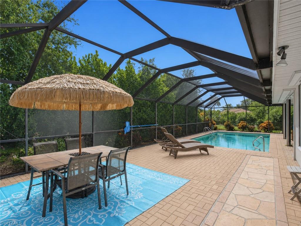 Discover the appeal of Marco Island living in this beautifully updated and tastefully furnished 3-bedroom, 2-bath residence, ideally positioned on a quiet street just minutes from the island's renowned white-sand beaches and the casual waterfront seafood restaurants, and live entertainment. Freshly painted and designed for effortless indoor-outdoor living, the bright, open floor plan is enhanced by vaulted ceilings, tile flooring throughout with carpet in the bedrooms, wide baseboards, and beautifully remodeled baths with coastal charm. The kitchen features granite countertops, stainless steel appliances, and a cozy breakfast and dining area. The spacious primary suite offers a walk-in closet and a beautifully remodeled bath featuring a double vanity and a walk-in shower, while the guest bath has also been tastefully renovated. Expansive sliding glass doors open to an oversized screened lanai with brick paver decking, offering an extra-large patio and sparkling pool in a private tropical setting—perfect for relaxing afternoons and entertaining. Thoughtfully maintained with a new roof (2024), air-conditioning system (2022), electric and manual hurricane shutters, and the advantage of a higher elevation with NO FLOOD INSURANCE REQUIRED. Whether you're seeking a full-time residence, seasonal retreat, or investment opportunity, this exceptional island home offers comfort, style, and an outstanding Marco Island location.