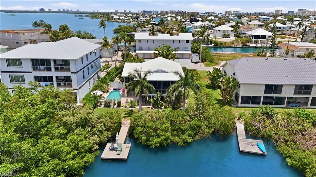 Positioned in one of Fort Myers Beach’s highly attractive local rental zones, this elevated 3-bedroom, 2-bath home with a versatile den offers a compelling opportunity for investors seeking both income potential and long-term upside. Located just across the street from a wide, desirable beach access, the property is ideally situated to appeal to vacation renters looking for convenient beach proximity, outdoor recreation, and the relaxed island lifestyle.

Set along a peaceful lagoon, the home offers an inviting backdrop for paddleboarding, kayaking, fishing, and enjoying tranquil water views. While there is no Gulf access, the lagoon setting creates a unique and memorable rental experience, enhanced by the oversized elevated screened-in back porch with western exposure—perfect for sunset views and outdoor living.

Inside, vaulted ceilings and abundant natural light create an open, airy feel, while the private pool and covered parking below add functionality and guest appeal. The location further strengthens the investment story, with close proximity to Santini Marina Plaza and the exciting future redevelopment of the former Outrigger property nearby—both of which are expected to enhance the south-end experience and benefit future renters.

A strong blend of rental potential, beach access, lifestyle amenities, and future neighborhood upside, this property is a standout opportunity in the Fort Myers Beach market.