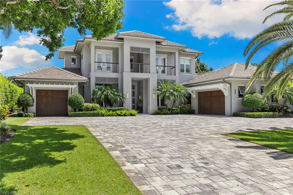 Welcome to 745 Riviera Drive — a stunning Modern Transitional masterpiece nestled on one of the most prestigious streets in The Moorings. This award-winning residence offers a rare blend of timeless architecture, cutting-edge technology, and sophisticated Florida living at its finest.  Spanning 4,912 sq. ft. under air, this custom-built home features 4 spacious bedrooms, 4.5 designer bathrooms, a private office, bonus room, gym, and 3 car garage offering both comfort and flexibility. Wide-plank wood flooring flows throughout the main living area, complementing the clean lines and warm textures that define this home’s architectural elegance. The heart of the home is a chef’s dream kitchen, featuring custom cabinetry, dual islands, two dishwashers, two beverage drawers, a wet bar with ice maker, and top-of-the-line appliances including a Miele 8 burner gas cook top all seamlessly integrated withControl4 Smart-Home technology for lighting, audio, televisions and HVAC.  A true showstopper, the brick-walled wine room is framed by a dramatic floating staircase with stainless steel cable railings and a sleek glass enclosure—perfectly blending form and function.  The spa-inspired primary suite offers a serene escape, with floating walnut vanities, pearlized glass tile accents, and concrete-style flooring that add modern sophistication to the luxurious bath.  Designed for the ultimate in indoor-outdoor living, the approx. 1,000 sq. ft. outdoor living area includes a brick-wrapped. fireplace, summer kitchen with refrigerator, gas grill, and built-in ice cooler—ideal for entertaining year-round.  Enjoy the Florida sun by the oversized pool and spa, surrounded by striking fire bowls, lush landscaping, and thoughtful design to maximize privacy and ambiance.  Additional highlights include: full-home generator, electric hurricane and screens on the lanai * NEW exterior paint Dec 2025 * 3 NEW A/C units * 2 laundry rooms, linear indoor fireplace and meticulously curated furnishings. This home is a rare opportunity to own a one-of-a-kind residence in The Moorings—proximity to Moorings Private Beach, shopping and dining while offering unmatched quality, location, and lifestyle. X FLOOD ZONE AND SITS 13 FT IN ELEVATION.