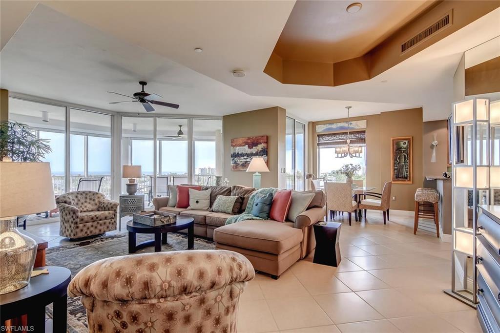 Breathtaking and Expansive Sunset views of the Gulf of Mexico, Manatee Bay, Estero Bay, Sanibel Island and North Naples from this Extra Large 4 bed corner unit. Stellar views day and night. Condos in this stack are seldom available. Act now and claim your piece of paradise. PRIVATE GARAGE INCLUDED. An absolutely exquisite interior design featuring top of the line  appliances, Gorgeous granite, Diagonal tile, and furnishings throughout. An extended wraparound lanai w/ Built in outdoor grill allows for relaxing days/nights. All the amenities you could imagine: Resort style pool & spa with Lush tropical vegetation; Steam room, Saunas, Fitness room and Grand Social room, gated community. With Deeded Beach access. This will not last. Schedule a showing now!!