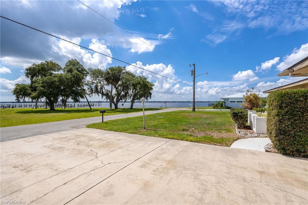 Boat Lovers Paradise! This beautiful, newly remodeled home is located just 200' from the Caloosahatchee River offering gorgeous views, and a canal front boat dock with concrete seawall (Boat lift is not operational). Inside this 2 bedroom 2 bath beauty you will find easy care tile and vinyl floors, a beautiful updated kitchen and plenty of room for entertaining! Outdoors relax in your own heated, salt water pool that is protected with screened cage. A larger sized 2 car garage is the perfect spot for hobbies as well. This tranquil location is on a dead end road and simply a Peaceful Paradise. Sunrise in the morning overlooking the river and sunset in the evening in your pool overlooking the canal. Life has it's rewards and this home is one of them. Schedule your showing today.