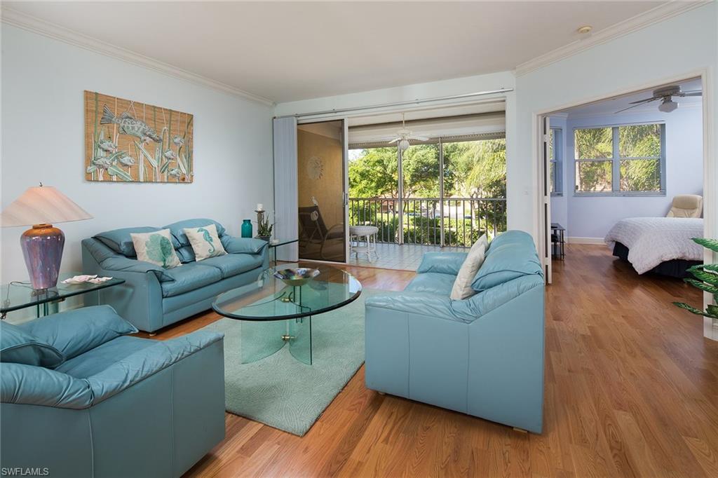 This prime location in Pelican Bay, St. Vincents is located in Crown Colony, a 24-hour gated community between the two tram stations, each five minutes to the warm sunny beaches of Naples. Enjoy this second-floor home with three bedrooms, an eat-in kitchen, spacious dining and living room featuring oak wood flooring and an updated kitchen with quartz countertops and stainless steel appliances. A lanai with electric storm shutters overlooks the sparkling lake and fountains plus western exposure for the best sunsets. The morning sunrises can be enjoyed from the open front porch. This end residence is turnkey furnished and ready to move into now. There is an extra-large storage room right outside the front door. Call now for the opportunity to own a condominium in a small complex in truly one of the best locations in Pelican Bay.