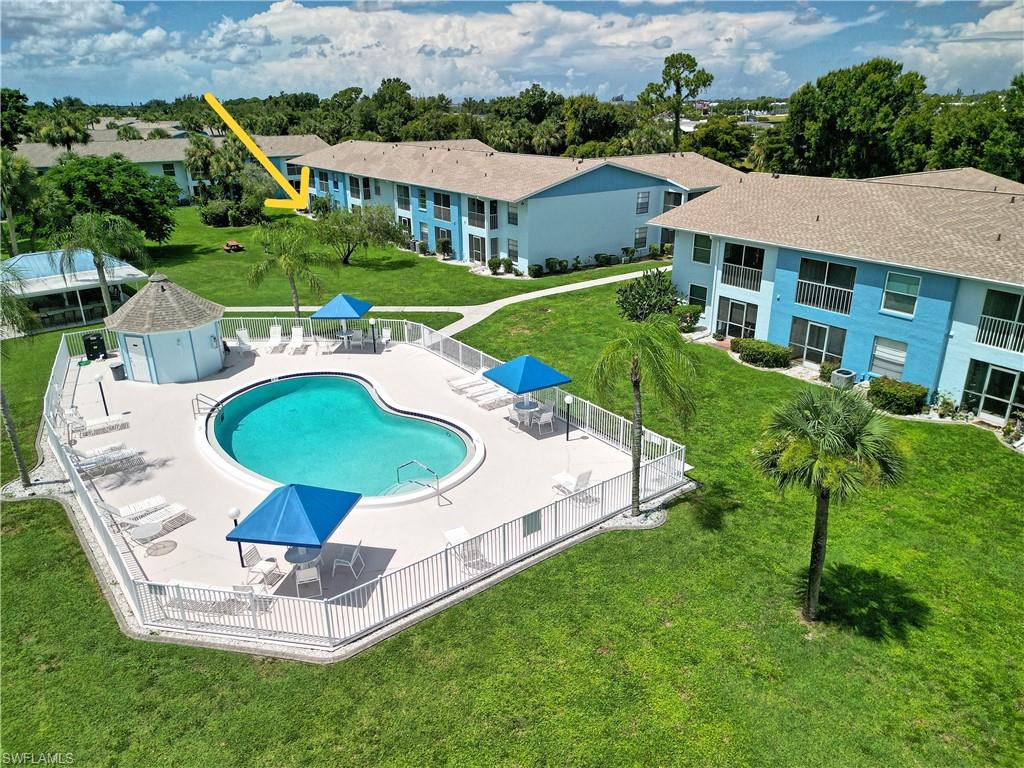 Low HOA fees of just $399 per month make this first-floor end-unit condo an excellent value. The monthly fee includes water, sewer, building insurance, roof maintenance, and exterior maintenance. Inside, tile flooring runs throughout. The updated kitchen features granite countertops, stainless steel appliances, soft-close cabinetry, and a breakfast bar. The split-bedroom floor plan places the primary suite at the rear of the home with a walk-in closet and step-in shower, while the guest bedroom and full bath are located at the front for added privacy. The living area opens to a screened lanai overlooking tropical landscaping. Covered parking is located just steps from the front door. Royal Hawaiian Club is a pet-friendly community with two heated pools, BBQ areas, and a pavilion. Located outside of a flood zone and just minutes from shopping, dining, and the Fort Myers River District, this condo offers affordable, low-maintenance living in a convenient location.