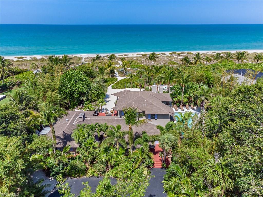 Welcome to Bali Hi, a tropical island Paradise on the Gold Coast on Captiva Island. These 2 acres lush, landscaped estate offers 155 ft of white sugar sand beach frontage on a high ridge dune setting. Located in an area along the beach on one of the highest elevations on Captiva where it’s known to capture sand maintaining a wide private beach feel. This estate zoned property offers main house, guest house & pool with the ability to add an additional guest house & tennis court. if you desire. The laid-back large cottage feel offers great space with w/multiple indoor/outdoor gathering areas to play & relax. The slightly elevated main residence offers. 4 BR & 4 BA areas w/lots of character & charm w/3 fireplaces, tongue & groove & heart pine finishes & a20 X 40 pool area. The 2 BR 2 BA guest cottage offers privacy for guests with w/kitchen and family room. This property faces due west enjoying magical sunsets & an occasional green flash if you’re lucky to see. Incredible rental property gross $600K year!