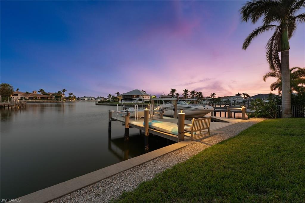 If you are looking for perfection, look no further! 2021 13-foot Boston Whaler Super Sport boat included. Quick direct boating access to the river and Gulf, southern exposure for shimmering natural light, dramatic long and wide water views, exceptional floor plan with open kitchen, soaring ceilings and plentiful windows. Exquisite decorating and numerous upgraded features throughout. This stunning quality-built home impresses from the moment that you walk in the door, immediately viewing the pool and water, definite "wow" factor. Features throughout include 4 bedrooms and 3 ½ bathrooms, coffered ceilings, luxury lighting, generator, impact glass and butler’s pantry with wine chiller. Beautiful private dock and multiple lifts. Expansive glass sliders lead you to the spacious outdoor living with screened-enclosed heated pool with water feature and a built-in gas grill. The gorgeous open kitchen has a large island with cooking prep station, granite counters, glass backsplash, white cabinetry, walk-in pantry and recessed, under-cabinet and pendant lighting. For boaters, the Gulf is a short boat ride away. Conveniently located near the beach, boutiques, dining, museums, golf and parks.