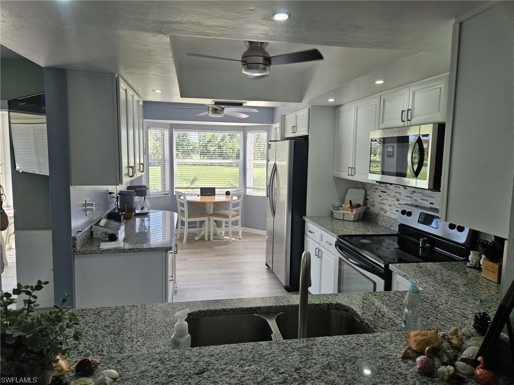 Enjoy the ultimate Southwest Florida lifestyle in this beautifully updated 2nd floor unit. This move-in-ready condo offers fantastic views and modern upgrades, perfect as an investment property, seasonal or full-time residence. The interior features a new kitchen with upgraded finishes, newer tile flooring and carpeting in bedrooms and an updated guest bath. A spacious primary suite serves as a private sanctuary, complete with a beautifully renovated bath featuring a tiled walk-in shower extra closet space and upgraded fixtures. Major systems offer complete peace of mind, including a newer A/C and hot water heater. Newly tiled lanai overlooking the golf course plus a reserved covered carport space. This unit is located in one of the few sections in the community that don't charge the mandatory golf bundle which saves approximately $2500 per year. With a Social Membership, residents still enjoy access to the championship 18-hole golf course, tennis, pickleball, bocce, and a state-of-the-art fitness center with daily classes. The remodeled clubhouse includes a beautifully designed dining and bar area. A large outdoor café with new bar, firepits and comfortable seating that leads to a large walk in resort style pool. Don't miss this rare opportunity to own a piece of paradise in one of Naples' most prestigious communities. Bring all offers!