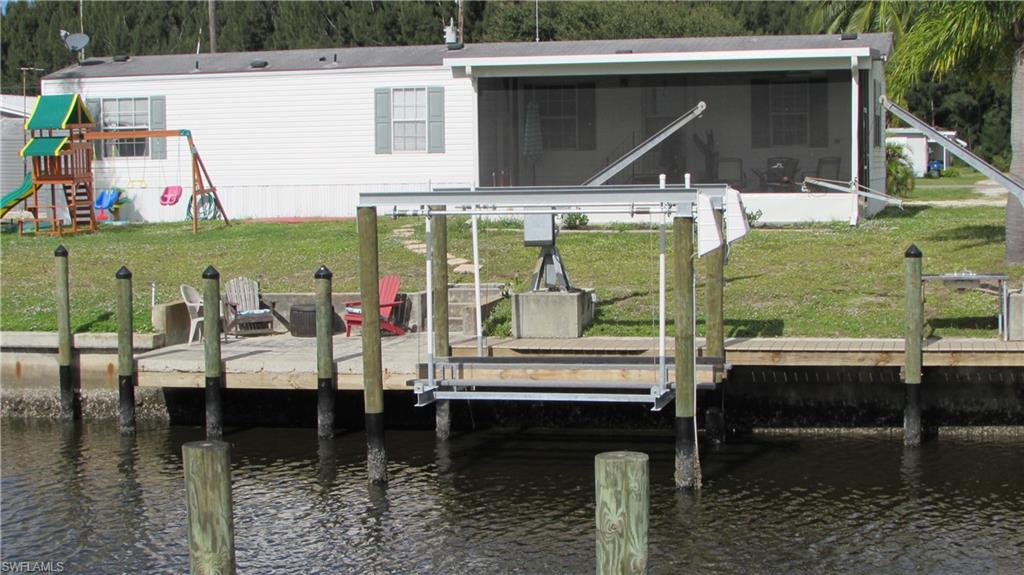 TWO HOMES FOR THE PRICE OF ONE. Two well maintained homes with Gulf Access. The homes are on a lot in Flamingo Bay that is street to canal and quick access to Pine Island Sound and the Gulf. The 2005 built, 960 sq ft has 2 bedrooms, 2 baths, open floor plan, screen porch and views of the water. Brand new dock, 7000 lb boat lift, new range and dishwasher. The 2 bedroom 1 bath home with a screen porch was rebuilt in 1974, 672 sq ft, new A/C, washer & dryer, new flooring and freshly painted. 2 car carport in between homes along with a shed. These homes can be investment property, weekend homes for you and friends/family--Plenty of Room for Everyone.