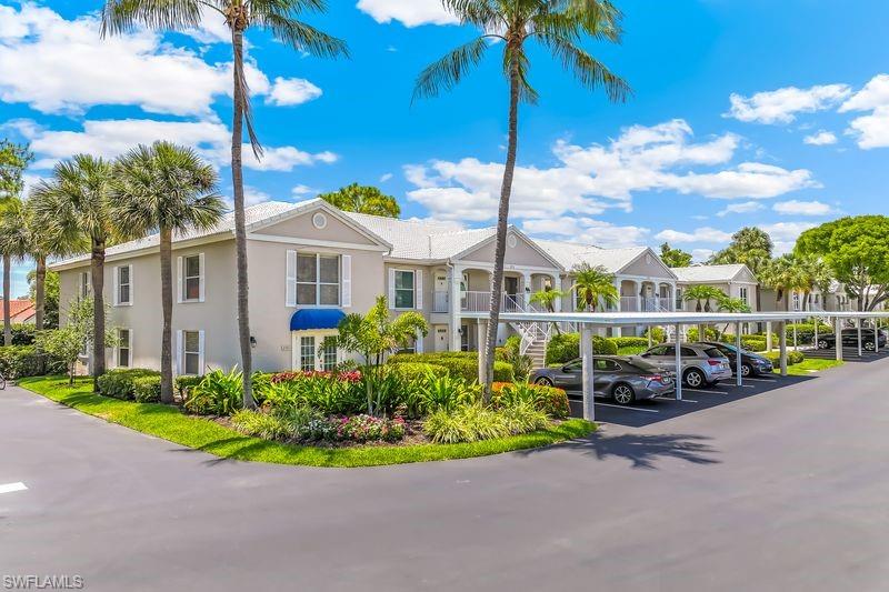 ONE MILE WALK OR BIKE TO VANDERBILT BEACH! The seller is replacing the Polybutylene plumbing. This is an ideal North Naples property, perfect for personal use, investment, or seasonal rental income, offering a rare opportunity to own a highly sought-after 2-bedroom plus den, second-floor end-unit condo with tranquil, private views from a sunny, bright west-facing screened lanai. Central A/C is only 2 years old, and the hot water heater is only 4 years old. Located in one of the most desirable areas of North Naples, you can easily walk or bike to Vanderbilt Beach, The Ritz-Carlton, Mercato, Pelican Bay Community Park, Paragon Theater, LA Fitness, Whole Foods, Publix, and countless dining and shopping destinations. Inside, this spacious condo features two full bedrooms, a den/bonus area, two full bathrooms, a large eat-in kitchen, vaulted ceilings, and a bright open-concept living space designed for comfort and entertaining. Enjoy the fully enclosed lanai complete with a built-in outdoor kitchen and cooktop—perfect for year-round grilling and relaxation—along with in-unit laundry, an interior storage closet at the front entry, and covered parking. The Pavilion Club community has recently completed numerous improvements, including fresh exterior paint, new awnings, upgraded carports, a new perimeter privacy wall, a new secure front entry gate, community grilling stations, and a newly paved parking lot with enhanced landscaping. With the ability to lease up to 5 times per year (minimum 30 days) and strong financial reserves, this community offers excellent income potential. Relax by the lakeside pool and tiki hut and enjoy the very best of the Naples lifestyle right outside your front door.