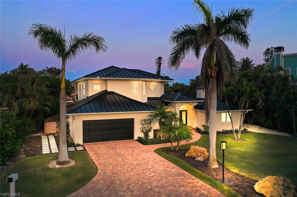 Welcome to this breathtaking, light-filled, airy modern masterpiece, every detail has been thoughtfully designed. Elevated wood panel ceiling sand an open layout this luxury home blends high-end fixtures, cutting-edge finishes and sophisticated design to create the ultimate living experience. As you step through the inviting foyer, you're immediately drawn into the heart of the home-the expansive chef's kitchen-completely redesigned and reconfigured for both style and function, featuring Monogram appliances, including a built-in refrigerator and freezer, induction cooktop, wall oven, and microwave drawer. Additional upgrades include, custom range hood, Rohl sink and faucets, custom cabinetry and stunning alabaster pendant lights. A bar island with integrated ice maker, and Elkay bar sink adds even more functionality to this culinary haven. The open-plan great room and dining area offer an ideal space for entertaining or relaxing, with large sliding doors that lead to the canal front screened pool deck where you can embrace the Florida lifestyle year-round. The luxurious primary suite is a tranquil retreat with alabaster nightstand pendant lights and a cozy fireplace. The spa-like bathroom features custom limestone herringbone floors, Waterworks shower fixtures and faucets, custom vanity with two Robern uplift mirrors and backlit onyx light feature. The custom walk-in closet designed for ample storage for all of your belongings. With four spacious bedrooms and 4 ½ baths, this home offers a perfect balance of privacy and shared spaces. The two primary suites provide flexibility for multigenerational living or hosting guests. The large guest rooms easily accommodate king-sized beds, ensuring everyone has their own sanctuary. The guest bath features exquisite marble tile flooring and a custom vanity, while the powder room boasts stone flooring with a Robern vanity and elegant marble faucet handles. Outside, the pool deck offers the perfect spot for al fresco dining, with sweeping views of the water. Whether you're entertaining or relaxing by the pool, the outdoor space is designed for ultimate enjoyment. Enjoy superior boating access from a wide, deepwater sea walled canal. Your boat is just moments away from the Bay, with an Azek dock and boat lift ready for your aquatic adventures. Plus, you’ll have private, deeded beach access allowing you to enjoy the best of both the water and the sand. Additional features include epoxy flooring in the garage, an Elkay chilled bottle filler, all-new plumbing and electrical systems, a 2023 AC system, a 2023 standing seam metal roof, new gutters, and new LVP flooring on the stairs and upper level. Every aspect of this home has been meticulously crafted for modern luxury living, ensuring comfort, style, and convenience at every turn. Located on the east end of Sanibel, with easy access on and off the island, this exceptional home is a rare find—offering luxury, stunning design, and the ultimate Florida lifestyle.