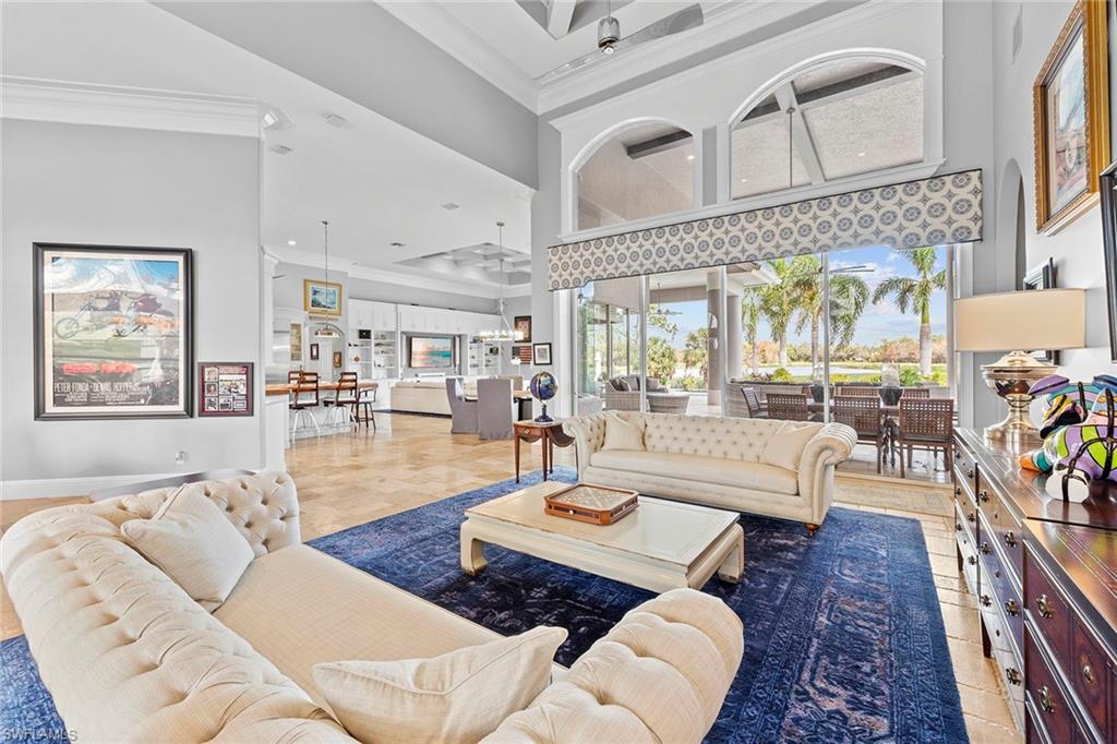 This architectural marvel offers exceptional features that set it apart from any other property in Quail West. Intricate woodwork and coffered ceiling accents lend the residence a timeless grandeur, while coastal influences imbue it with a laid-back ambiance throughout. The main living spaces flow seamlessly, from the grand salon to the family room, encouraging grand gatherings and intimate moments. The kitchen, built to inspire gourmet creations and effortless entertaining, could easily have been designed by a career chef from the layout to the professional-grade appliances that cater to the highest culinary standards. A dedicated butler’s pantry and a separate pantry enhance the kitchen's functionality, making it ideal for hosting gatherings of any scale. Beyond its main living spaces, this home stands out with extraordinary accommodations. A fully independent annex in the residence, ideal for a caretaker, au pair, or as a private home for a mother-in-law or extended family, offers a separate entrance and seamless access to the main home. This self-contained retreat includes a well-equipped kitchen, cozy dining nook, living area and a spa-like bath, delivering the ideal balance of comfort and solitude. Further enhancing the home's appeal is a separate casita off the pool, providing a resort-style sanctuary for older children, visiting family members or guests. Thoughtfully designed, this charming space ensures every stay is memorable, combining privacy and luxury in equal measure. Outdoor living is equally impressive, with a sprawling lanai overlooking the golf course, a sparkling pool, spa, and abundant lounging and dining spaces. Complete with a full outdoor kitchen, this space transforms everyday living into a vacation-like experience. This estate is a testament to exceptional design and effortless living, unquestionably one of the most distinctive properties in Quail West.