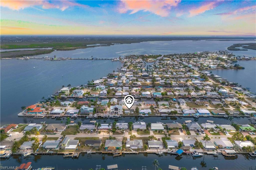 YOUR MATLACHA WATERFRONT DREAM STARTS HERE – FULLY RENOVATED 3+DEN / 2 BATH – DIRECT GULF ACCESS! ALL HURRICANE IMPACT WINDOWS AND NEW ROOF - all the work has been mdone for you! Imagine waking up every morning to the calm of the water, sipping your coffee while boats drift by and the island comes to life. This beautifully updated waterfront home is not just a place to live it is a lifestyle you’ve been waiting for. Located in the heart of Matlacha, this 3 bedroom plus den, 2 full bath residence has been lovingly refreshed with a completely redone kitchen and brand-new bathroom with tile throughout, creating a bright, modern space that feels both stylish and welcoming. The open layout invites you to gather, relax, and entertain with ease. The den offers the flexibility today’s buyers crave your home office, reading retreat, or extra space for visiting friends and family. Every room is filled with natural light, making the entire home feel warm and connected to the outdoors. Step outside and you are instantly on island time. The property sits on an oversized lot, providing ample space for outdoor living, and there’s plenty of room on the side of the house for RV or boat parking. With direct access to Matlacha Pass, your days can be spent fishing at sunrise, kayaking through quiet canals, or cruising to nearby waterfront restaurants for dinner. This is the Southwest Florida lifestyle simple, relaxed, and unforgettable. Waterfront homes like this rarely become available in Matlacha, especially ones that are fully renovated and move-in ready. If you have been waiting for the right home, this is it.