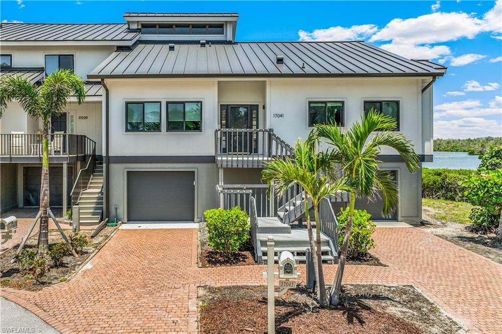 ONE OF THE BEST VIEWS ON GORGEOUS CONNIE MACK ISLAND! THIS ISLAND IS ONE OF THE MOST DESIRED LOCATIONS. This amazing corner townhome seldom comes on the market! A boater's paradise w/deep water, and quick access to the Gulf of Mexico from your own convenient ASSIGNED 30' BOAT SLIP located close to your back door with amazing UNOBSTRUCTED PANORAMIC WATER VIEWS. Wake up each morning to this view and watch Manatees frolicking in your backyard! NEWER ROOF, IMPACT WINDOWS AND SLIDERS, HARDY BOARD SIDING, PAINTED EXTERIOR, ALL NEW APPLIANCES, 2 NEW AC UNITS, AND NEW WATER HEATER! Open floor plan concept, 2BR & LARGE LOFT AREA, can be converted to a 3rd bedroom, 2.5 BA. NEW vinyl flooring throughout the lower level area. Large first-floor Master bedroom en-suite and guest bedroom. ROOM FOR AN ELEVATOR. Gorgeous vaulted ceilings enhanced with an open staircase. The kitchen opens to the great room leading to the large under-covered lanai. OVERSIZED TWO-CAR attached garage. You are minutes from the Gulf of Mexico, Sanibel, and Captiva Islands. Gated community w/clubhouse, guest apartment, community pool & tennis/pickle-ball courts. Come live the FLORIDA LIFESTYLE on a PRIVATE ISLAND!