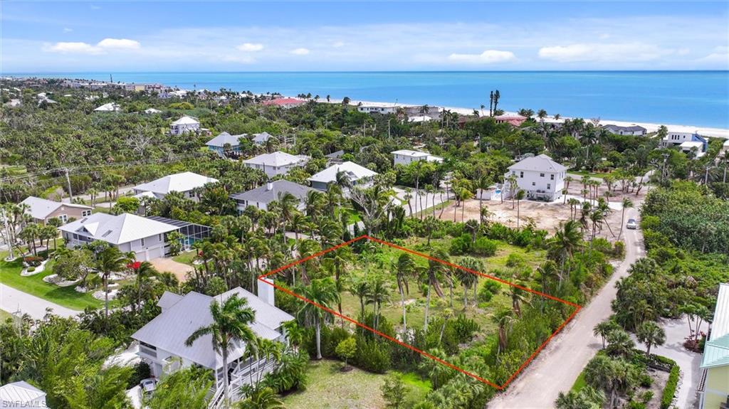 Rare opportunity on Sanibel's west end don't linger - and this one is priced to move with unmistakable intention. Nestled along the tranquil stretch of Sawgrass Place (a private road), this generously sized, cleared, and fully buildable residential lot sits within an enclave of upscale custom homes. Offering the kind of canvas that discerning buyers dream about. Beach access path just across West Gulf Drive places you steps from some of the finest shelling beaches the island has to offer - a stretch renowned for its pristine shoreline and unhurried Gulf-side rhythm. Electric, water and sewer connections are already in place, smoothing the path from vision to foundation. The natural surroundings here are nothing short of extraordinary. A short bike ride delivers you to the legendary J.N. "Ding" Darling National Wildlife Refuge, where winding trails thread through mangroves alive with native birds and coastal wonder. Bailey-Matthews National Shell Museum and Aquarium is just minutes away, as is A Bit of Bailey's General Store - the island's beloved neighborhood anchor for over a century. The Sanibel-Captiva Conservation Foundation's Marine Laboratory speaks to the ecological richness woven into everyday island life here. With impermeable coverage allowances of 25% and 30% for the developed area, there is meaningful flexibility to craft a thoughtfully designed residence that honors both comfort and the island's environmental character. Exclusive, serene and quietly removed from the bustle - yet never inconvenient - this is where your Sanibel story begins. Don't wait on this one.