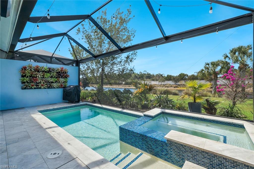 Water views. Spectacular Sunsets. Built in 2020, this Stunning 3 bedroom + DEN villa is in the award-winning Isles of Collier Preserve. This impeccably maintained residence offers an exceptional combination of quality, comfort, and thoughtful upgrades. Designed to embrace Southwest Florida living, the open-concept floor plan flows seamlessly to an expansive outdoor retreat featuring a stunning saltwater pool, panoramic lanai screens, and peaceful water views that provide the perfect backdrop for enjoying Naples' celebrated sunsets. You will be impressed with the amount of natural light. The kitchen has been thoughtfully enhanced with Thermador appliances, custom cabinetry, designer tilework, and beautiful quartz countertops, creating a refined yet functional space for everyday living and entertaining. Wood-grain tile flooring extends throughout the home, while French doors add character and flexibility to both the den and third bedroom. The spacious primary suite is complemented by custom California Closet systems, and additional upgrades include plantation shutters throughout, a whole-house water filtration and softener system, impact-resistant windows and doors, electric storm screens, and a whole-house generator for added peace of mind.   It is very bright and welcoming. This home offers additional confidence and convenience. A two-car garage and numerous premium improvements further enhance the property's appeal Including an extra-long driveway for plenty of parking for you and your guests. Residents of Isles of Collier Preserve enjoy more than 2,400 acres of preserved natural beauty, scenic waterways, miles of walking and biking trails, kayaking, pickleball, tennis, fitness amenities, resort-style pools, and the waterfront Overlook Bar & Grill—all just minutes from the shopping, dining, entertainment, and Gulf beaches of downtown Naples. A rare opportunity to own a highly upgraded waterfront home in one of Naples' most distinctive and naturally beautiful communities.