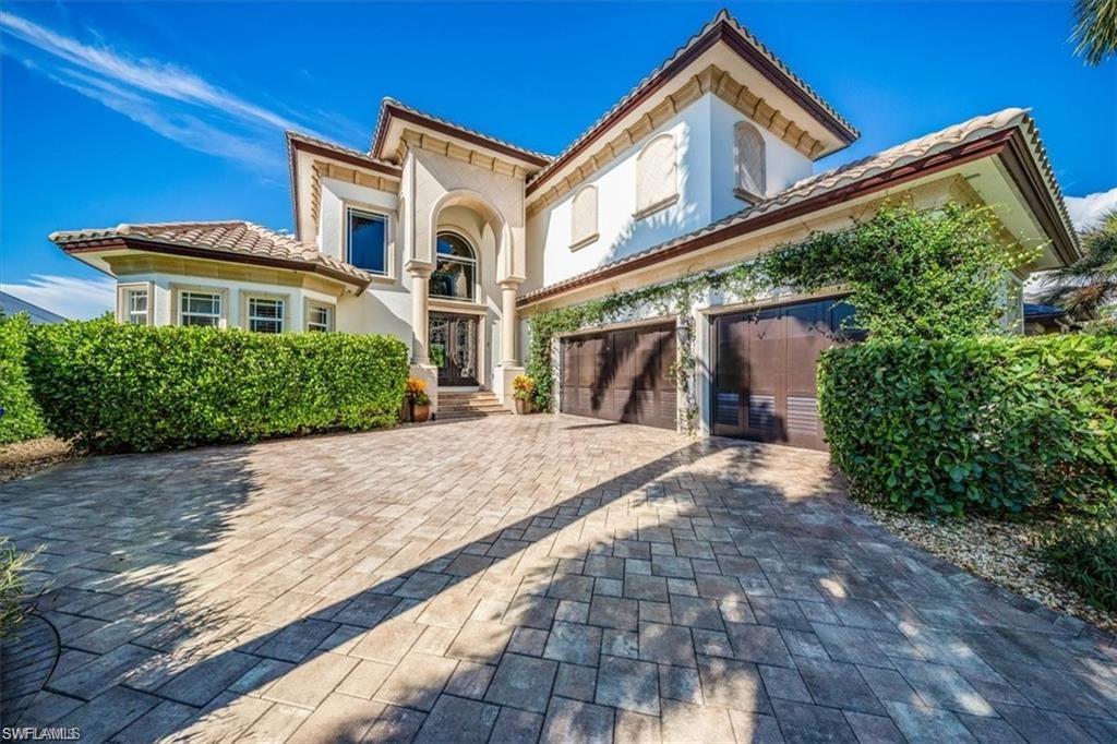The ultimate coastal lifestyle awaits with VIP amenities galore! Situated on the water seconds from Naples Bay with direct Gulf access and boasting a Trex dock and custom boat lift with a remarkable 30K lb capacity, this estate home offers an unparalleled experience for boating enthusiasts. Another highlight for boat owners is the ability to accommodate up to a 48-foot boat (including motors) on the custom lift, ensuring seamless and convenient access to the Gulf. Outdoor amenities include a resort-style pool with a slide, a spa, an outdoor fireplace, and an allseason kitchen the perfect setting for entertaining or simply enjoying breathtaking waterfront views. Pocketing sliding doors with automated window coverings connect the outdoors with the stunning interior. Indoors, revel in designer light fixtures, COREtec flooring, a feature wall with an electric fireplace in the expansive great room, and a 250-bottle wine cellar. The wet bar with luminescent backlit counters is the perfect spot for entertaining. Wind down in the evening in the upstairs theater room that seats 8. The chef's kitchen features Quartz counters, dual islands, and a custom dining table. Gourmet appliances include a Sub-Zero Refrigerator, GE Monogram induction cooktop, double wall ovens, and a builtin Miele coffee maker. The first-floor owner's suite is a sanctuary in itself, boasting an astounding spa bath, an enormous closet, and direct access to the pool deck. Upstairs, three additional bedrooms offer family and guests ample room for privacy and play. Located minutes from 5th Ave and sun-drenched Gulf beaches. Immerse yourself in the epitome of luxury living, where every detail has been meticulously crafted to create your dream oasis by the water.