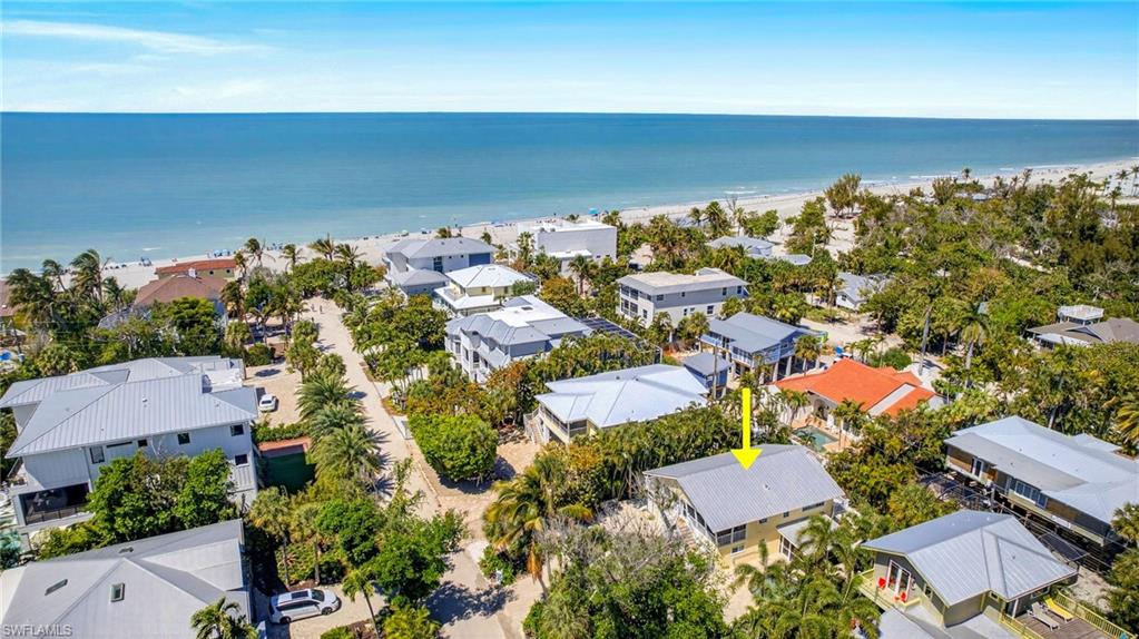 Looking for a "True" Captiva Beach cottage with conforming lower-level space, situated on a private lane just yards from the Gulf? This wonderful 4 bedroom, 3 bath cottage is surrounded by lush tropical vegetation with shell pathways throughout. Enjoy the large patio surrounding the fenced, heated pool and spa with Pebble Tech finish with a new pool heater and pump 2024. Perfect for dining alfresco and entertaining friends and family. The property offers two screen enclosed porches and a deck that wraps the house. Living/Dining Room combination with French doors that open to the upstairs porch and side deck. Kitchen with granite counters, custom cabinetry, breakfast bar, stainless steel appliances and also has a French door that opens to the porch. Bamboo wood floors and impact windows/doors throughout. Primary bedroom has a walk-in closet and French doors to the back deck that leads to a spiral staircase to the lower level and pool area. Upstairs guest bathroom has a linen closet. The newly remodeled lower level/cabana offers a kitchenette, tile floors throughout, living room, screened porch, guest bathroom with a walk-in shower and linen closet. Home is being sold partially furnished with exceptions. Keyed owner's storage on lower level. There is a two-car tandem garage. Great location in Captiva's "Village", walk to restaurants, shopping, the historic Chapel By the Sea and marinas. Enjoy the islands "World" Famous shelling, fishing, boating and gorgeous Captiva sunsets.