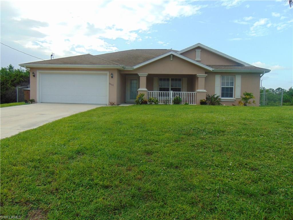 Welcome home to this meticulously maintained 3 bedroom + den single family home, located in one of the most convenient neighborhoods Lehigh Acres has to offer. Situated on a large 1/4 acre parcel of land, you will love the fully fenced backyard. Enjoy garden views from your own screened lanai! Inside the house, rich laminate-wood flooring and tall ceilings fill the living space, which features an open concept layout. White kitchen cabinetry and a decorative glass tile backsplash bring elegance to the kitchen. An adjacent room offers indoor laundry which leads to the large, attached 2 car garage. 3 spacious bedrooms, including a great master suite, are the perfect combination of comfort and functionality. Don't miss this beautiful property, built in 2005, with nearly 1600 square feet of living space, this is a move-in ready home! Grab your agent and call today for a private showing appointment!