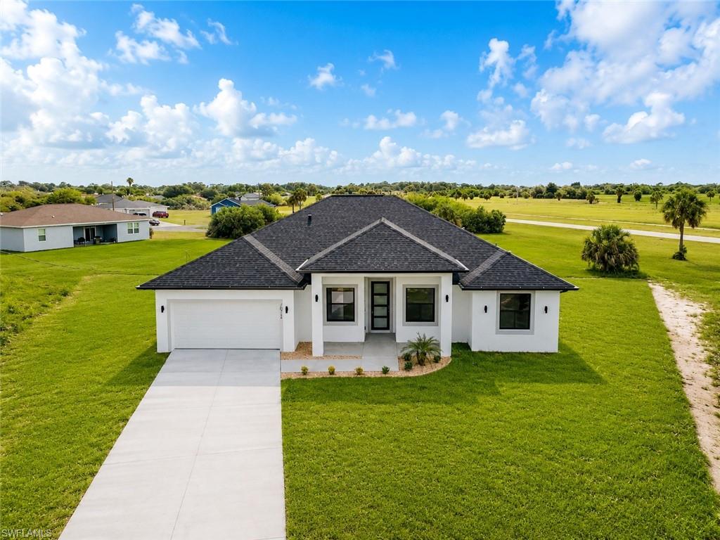 Experience the perfect balance of space, privacy, and modern luxury in one of LaBelle's fastest-growing communities. Situated on a spacious 0.31-acre homesite outside of a flood zone, this brand-new residence offers 4 bedrooms, a versatile den, 3 full bathrooms, and a 2-car garage—designed for today's families and flexible lifestyles.
The bright open-concept layout features soaring ceilings, elegant tray ceilings, luxury flooring throughout, and abundant natural light. At the heart of the home, the gourmet kitchen showcases quartz countertops, custom cabinetry, stainless steel appliances, designer fixtures, and a large center island perfect for entertaining family and friends.
The owner's suite serves as a private retreat, complete with a spacious walk-in closet and a spa-inspired bathroom featuring dual vanities, a freestanding soaking tub, and an oversized walk-in shower.
Built for comfort, security, and long-term value, the home also includes impact-resistant windows and doors, a dedicated laundry room, generous storage space, and a 10-year structural warranty.
Step outside to the covered lanai and enjoy the freedom of an oversized homesite with plenty of room for a future pool, outdoor kitchen, garden, RV parking, or entertainment area.
Rarely do you find a new construction home that combines modern finishes, oversized land, flood-zone advantages, and move-in-ready convenience in one package. Schedule your private showing today.