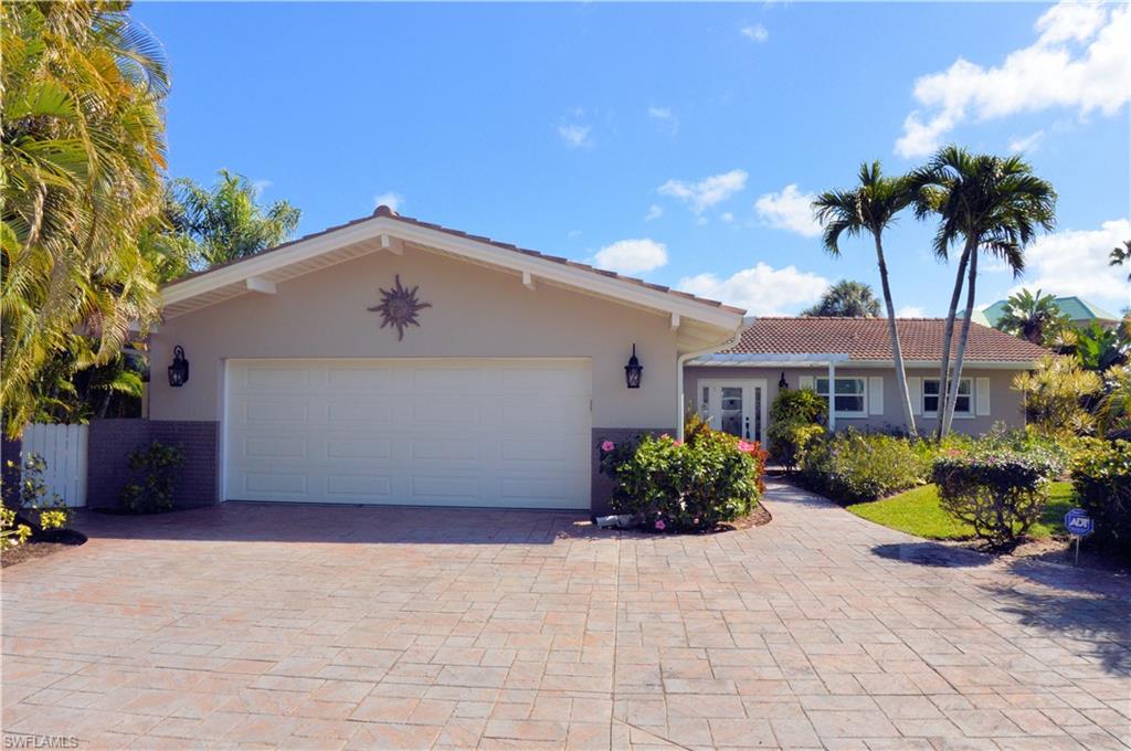 Located on Estero Bay, Fort Myers Beach. This beautifully appointed home is being offered furnished turnkey. Spacious 3 bedroom, 3 baths with over 2200 square feet, heated pool & spa.  Custom wood cabinetry, tile, impact windows & sliders. Approximately 175 lineal feet of wraparound seawall with covered dock with 24lb lift and a separate jet ski lift and dock. The pool area is caged with expansive views of the bay. Home also offers a great side yard that is fenced for the dogs! Randy Lane is mid island, very close to Publix, Bayfront Bistro and Snook Bight Marina, and has very high elevation on the island. Dual A/C System and mini split in the garage to keep your toys in good condition.  Lush landscaping completes this home to offer additional privacy.