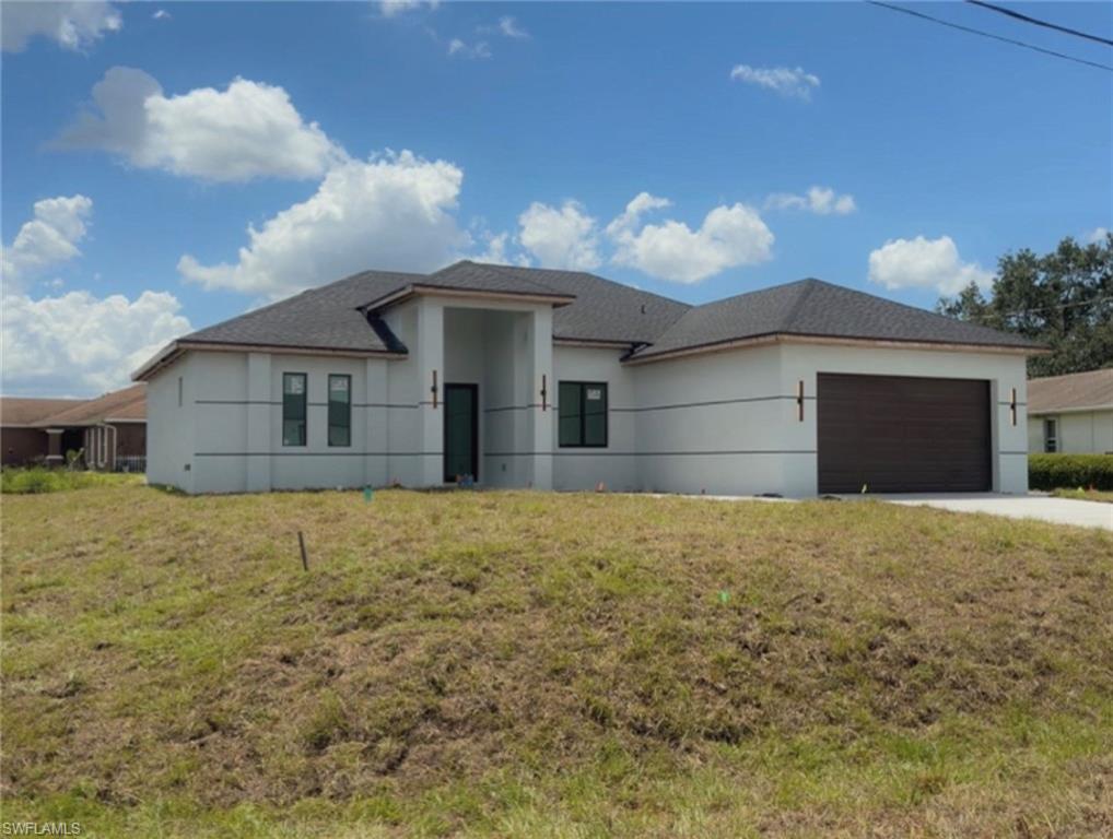 Brand-New Construction in Lehigh Acres! This stunning 4-bedroom, 3-bathroom home offers a modern open-concept design with spacious living and dining areas perfect for entertaining. The gourmet kitchen overlooks the main living space and features ample cabinetry and countertop space. The private primary suite includes dual walk-in closets and a luxurious ensuite bath. Enjoy the convenience of a separate laundry room, a 2-car garage, and a covered lanai ideal for relaxing outdoors. Featuring soaring 10-foot ceilings throughout and an impressive 14-foot entry ceiling, this home provides a bright and elegant atmosphere. Conveniently located near schools, shopping, dining, and major roadways. Don’t miss the opportunity to own this beautiful new construction home in a growing area of Lehigh Acres!