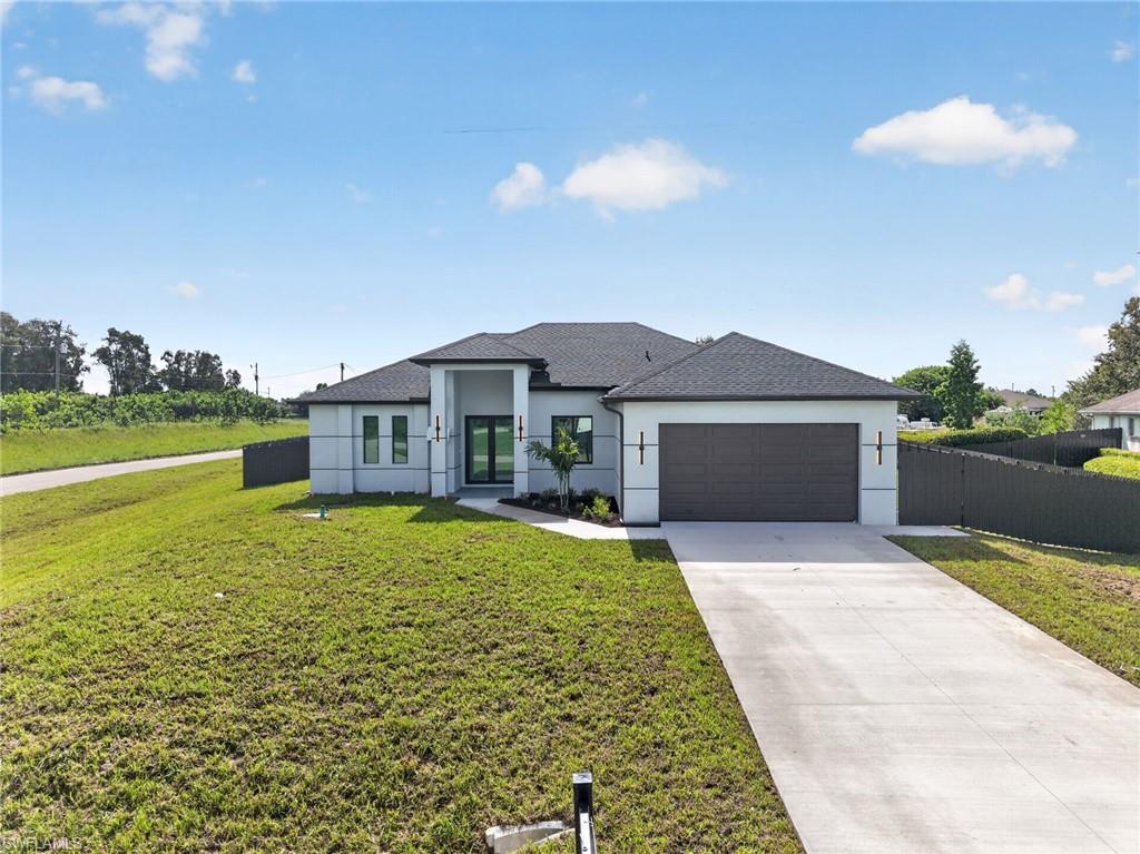 Brand-New Construction in Lehigh Acres! This stunning 4-bedroom, 3-bathroom home offers a modern open-concept design with spacious living and dining areas perfect for entertaining. The gourmet kitchen overlooks the main living space and features ample cabinetry and countertop space. The private primary suite includes dual walk-in closets and a luxurious ensuite bath. Enjoy the convenience of a separate laundry room, a 2-car garage, and a covered lanai ideal for relaxing outdoors. Featuring soaring 10-foot ceilings throughout and an impressive 14-foot entry ceiling, this home provides a bright and elegant atmosphere. Conveniently located near schools, shopping, dining, and major roadways. Don’t miss the opportunity to own this beautiful new construction home in a growing area of Lehigh Acres!