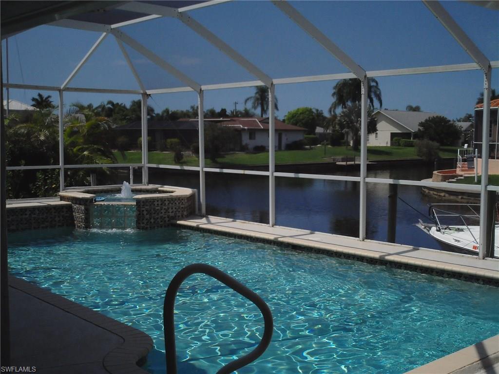 Reduced Move-In Ready! Love Location,Boats,Cars then this is for You*Direct Sailboat Access in 15 Minutes from 120' Concrete Dock/Davits Triple Lot w/Mesmerizing Intersecting Canal Views*This Elegant Upgraded 3 Bdrm/3 Bath Beauty has a 5.5 Car Area (43X28) 4 Car Screened Garage complete w/Add'l Back Garage Door/Add'l Electric in Ground-Walls/AC Wall Unit/Built-Ins & 2 Pull Down Stairs to Storage Attic-Sweet!*Relax in The 2002 Blt.Zoned Heated Pool / Spa w/Autofill*Indulge Florida Lifestyle from Ovrszd Tiled Lanai w/Granite Outdoor Kitchen & Full Outdoor Bath*Dbl.Screen-Dbl.Door High Foyer Tiled Entry into a Super Flowing Floor Plan w/ Sliders from Master,Living & Family Rm*Cathedral/Vaulted Ceilings throughout & Excellent Use of Striking Accent Windows to Take in Breathtaking Views*Remodeled Kitchen w/Granite Counters-Wood Cabs-Under Sink R/O-Walk-In Pantry & Pass Thru Window to Outdoor Kitchen*Master Walk-In Lifetime Cornerstone Shower, Large Bathing Tub, Dual Sinks & Auto Light for Enormous Walk-In Closet*Built-In Weather Station*Built-In Wood Entertainment Center*Central Vac*Wired Security*Zoned AC New 10/14*Wtr Htr 2014*New Washer/Dryer/Ceiling Fans*Pool Htr 2015*Visual Tour