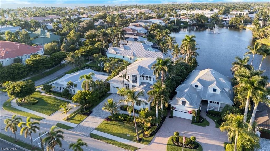 Experience the epitome of luxury living in this exceptional new construction home, perfectly situated in the heart of Olde Naples. Crafted by Refined Builders, this remarkable residence presents a rare opportunity to own a true masterpiece in one of Naples’ most coveted locations. Ideally positioned just minutes from the world-class dining and shopping of 5th Avenue South and 3rd StreetSouth, as well as Naples’ iconic beaches, this 4-bedroom + den, 5.5-bath home offers the perfect blend of luxury, comfort, and convenience—complemented by tranquil lake views from the 2nd floor and lush tropical landscaping. Wide-plank European oak floors and tongue-and-groove ceilings set a sophisticated tone, while the expansive great room flows seamlessly into a stunning gourmet kitchen featuring a quartz-clad center island, sleek two-tone cabinetry, and a full suite of premium Thermador appliances—ideal for both everyday living and elegant entertaining. Sliding glass doors lead to your private outdoor sanctuary, complete with a resort-style saltwater pool and spa, custom summer kitchen, and a spacious covered lanai—perfect for seamless indoor-outdoor living. The first-floor primary suite is a luxurious retreat with direct pool access and a spa-inspired bath featuring a soaking tub, oversized walk-in shower, and dual vanities. Upstairs, three ensuite guest bedrooms—including a VIP second master—are accessible via stairs or a private elevator. A bonus living room with wet bar, scenic balcony, and captivating lake views provides a relaxed space to unwind or entertain. Additional highlights include dual laundry rooms, a 3-car garage, tankless water heater, whole-house generator, and propane tank.