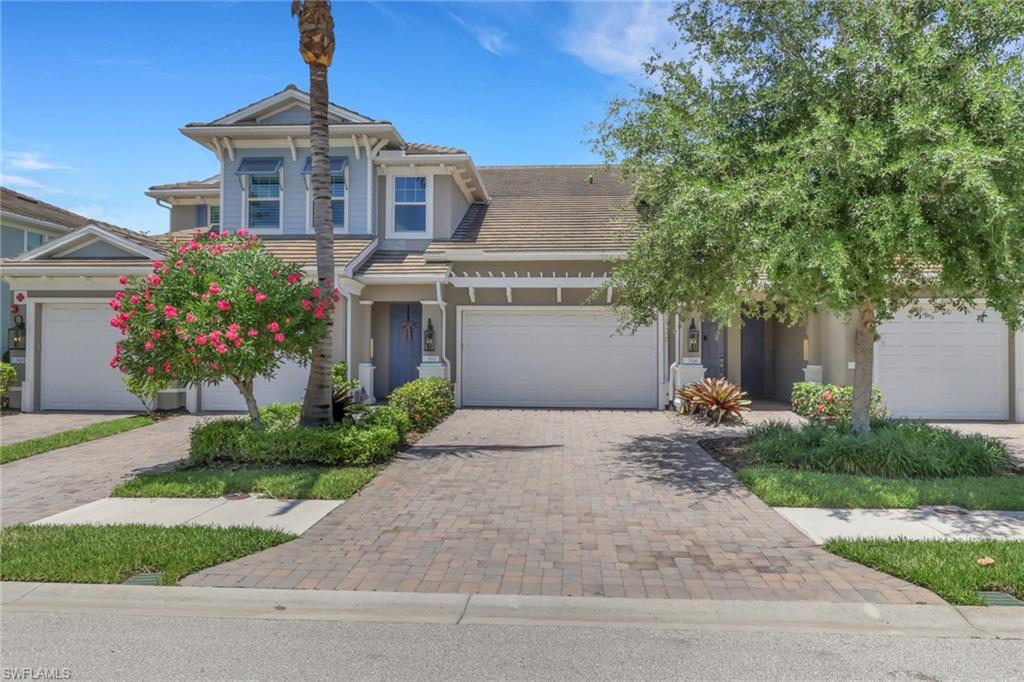 Enjoy peaceful lake views from this beautifully maintained second-floor coach home in the gated community of Richmond Park in North Naples. Built in 2019 by Neal Communities, this spacious Whitehaven floor plan offers 3 bedrooms, 2 bathrooms, and 1,725 square feet of thoughtfully designed living space featuring high ceilings, wood-look plank tile flooring throughout the main living areas and primary suite, carpeting in the two guest bedrooms, and an open-concept layout ideal for everyday living and entertaining.

The well-appointed kitchen showcases quartz countertops, stainless steel appliances, an oversized sink, tile backsplash, under-cabinet lighting, a large center island, and Moen fixtures, while custom shiplap accents, plantation shutters, and light-filtering roller shades add warmth and style throughout the home. The spacious primary suite offers a large walk-in closet and walk-in shower, and recent updates including fresh interior paint, newer carpeting, and a newer LG washer and dryer enhance the home's move-in-ready appeal.

Relax on the oversized screened lanai overlooking the lake, or take advantage of the attached 2-car garage complete with epoxy flooring and overhead storage. Impact-resistant windows and sliding glass doors, concrete block construction, and a tile roof provide added peace of mind. Residents enjoy access to a clubhouse, heated pool, and hot tub, while HOA fees include cable, internet/Wi-Fi, water, lawn care, exterior pest control, and exterior building insurance. Ideally located just minutes from Naples' world-class beaches, shopping, dining, and entertainment, this exceptional residence offers the perfect blend of comfort, convenience, and Florida lifestyle.