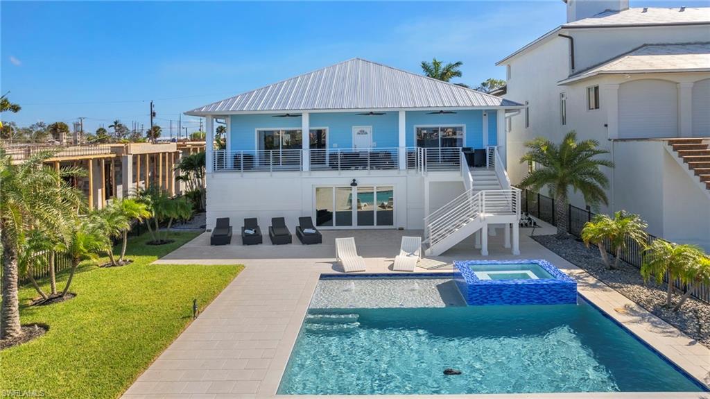 This Elevated BOATERS DREAM HOME on an OVERSIZED LOT is what waterfront living in Florida is all about! The Open Concept floor plan with panoramic BAY VIEWS is laid out for entertaining. The air conditioned 6 CAR GARAGE offers 2770 sqft of storage space while the main living spreads over 2850 sqft with oversized covered patios. There are THREE large bedrooms with full bathrooms. The most spectacular outdoor living space facing your very own captains walk leading to not just one but TWO DEEPWATER BOAT LIFTS will take your breath away. Take a quick boat ride and dine in one of the many waterfront restaurants. Enjoy your morning coffee on the oversized covered front porch catching the morning sun while the prime WESTERN EXPOSURE allows you to end the day with a glass of wine watching the SUN SET over Sanibel Island. This MOVE IN READY HOME was remodeled in 2021 and surrounded by mature palm trees and pristine and immaculately maintained landscaping additional to a NEW SALTWATER POOL AND SPA. A short walk to the BEACH and DOWNTOWN Fort Myers Beach yet a quick connection to the mainland are what makes this a highly desired location. Potential Gross Rental Income of $300k in 2025 onward.