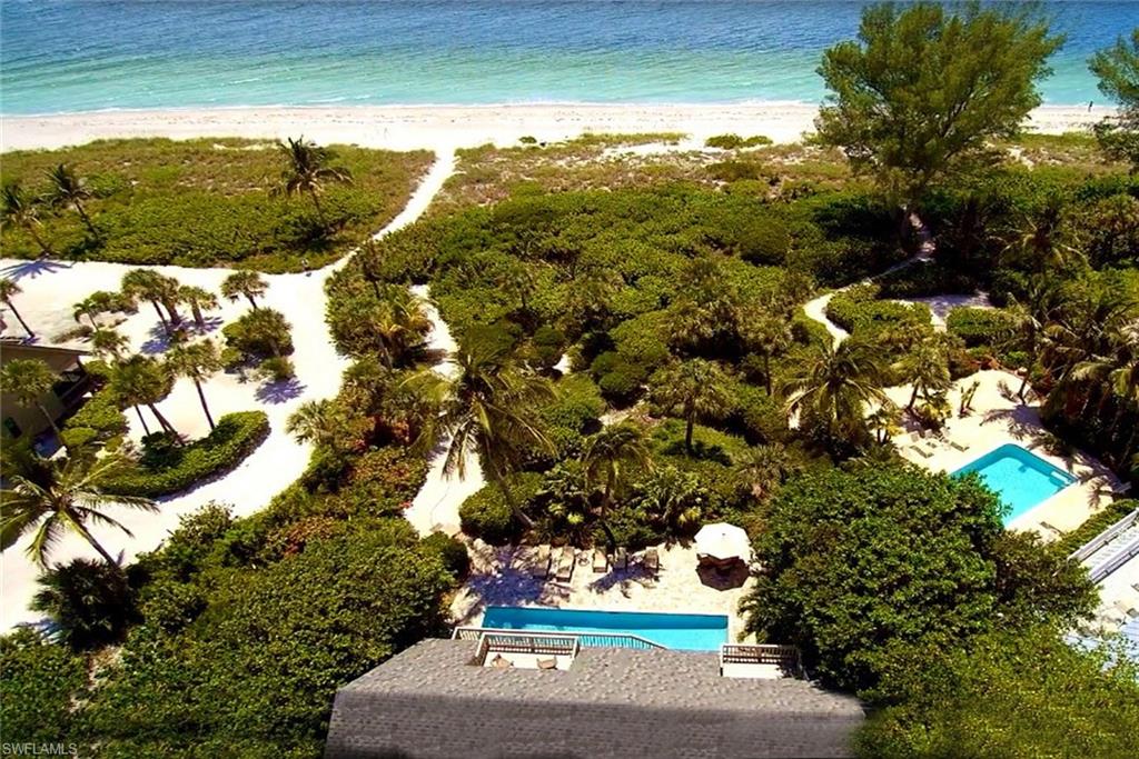 Beachfront living on a gulf front property only on Captiva Island! Stunning views of the sparkling gulf from walls of glass doors and windows. Set across a sandy beach, this beach house is what island life is all about. Designed to take in the breathtaking views and the warm tropical breezes, this casually elegant home will make one feel immediately relaxed. The master has walls of glass on two sides and seems to hang over the beach. Several decks add space for outdoor entertaining. With a main house of four bedrooms, four and partial bath, elevator, and a dramatic vaulted ceiling in the living room. This unparalleled and choice setting gulf front, dual level beach-style pool home. Highlights and elements including volume ceilings, stone flooring, granite counters, 10’ center island, WOLF gas stove, custom wood cabinets, vanities, interior doors, thick molding, impact resistant windows and doors. The sea lives in us and you'll come to call it home. Main and upper level master bedrooms, en-suite bathrooms, new lighting, plumbing and electric, spray foam installation, and insta-hot!  Professional design landscaping with lighting, pavers.
