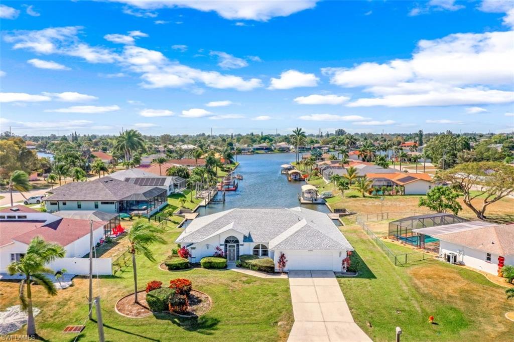 GULF ACCESS 1900+ SF FURNISHED HOME WITH STUNNING CANAL VIEWS!  Centrally located with close proximity to Downtown Cape Coral.  This split bedroom floor plan offers plenty of space and privacy with an open and airy pallet highlighted by natural lighting that highlights the volume cathedral ceilings.  Tile & carpet throughout with a FORMAL DINING ROOM, TWO LIVING AREAS, SPACIOUS BEDROOMS and more! Wake up in your MASTER BEDROOM to amazing straight down the canal views and a nice sized ensuite ready for your personal touches!  The guest bathroom has been designed for pool access and there is plenty of room for a pool!  The OVERSIZED lanai (400 sf) offers additional entertaining space with tile and ELECTRIC SHUTTERS.  The exterior of the home has mature landscaping, NEWER ROOF (11/2017) AND 100' OF SEAWALL with room for a dock!  Call to schedule your private showing today! *BE SURE TO CLICK ON LINK TO VIEW THE VIDEO & 3D TOUR OF THIS HOME!*