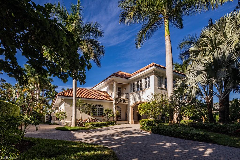 Charmingly situated on an expansive Port Royal estate lot, this gracious residence, with a timeless island colonial architecture and interior design, offers an exciting opportunity to enjoy bridge free access to the Gulf of Mexico and is convenient to the beautiful estuarial inland waterways. As functional as it is aesthetically pleasing, the home boasts a soaring two story living room with fireplace. An always sought after first floor master suite, well thought out family room, kitchen and formal dining room, den, separate office space and screened terrace are all easily accessible from the central living room space. There are five very accommodating guest bedrooms on the second level. A large pool deck, amidst verdant landscaping, with unique views over Runaway Bay, provides an exciting  opportunity for engaging outdoor entertaining. Port Royal Club membership eligibility.