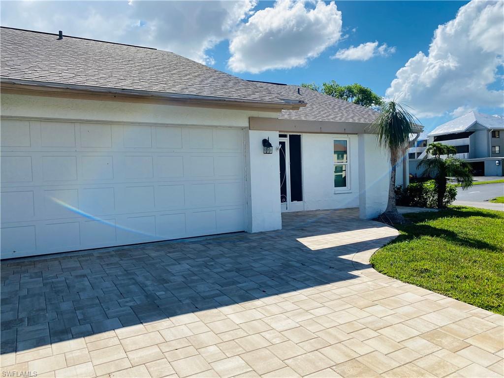 Come see this nicely decorated and fully furnished home with 2 car garage in popular Cinnamon Cove! Updates include beautiful luxury vinyl plank floors, island kitchen, extended living area into the Florida room, and a gorgeous master bath.  Great open floorplan for entertaining!  Did I mention the new pavers in the driveway and walkways and all the windows and doors are hurricane rated?  Very close to the clubhouse where the fulltime activities director will keep you busy with dinners, entertainment, trips, clubs, dances and more! Amenities include 4 pools, hot tub, tennis, pickleball, bocce, exercise room, billiards, fitness and more!  Condo fee $513 month includes master association, land/lawn, exterior painting and roofs (new roof 2022), irrigation, insurance, etc.  No flood damage and pictures are current.